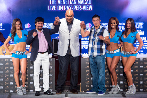 Heavyweight boxing legend George Foreman (centre) raises the arms of Manny Pacquiao (left) and Brandon Rios (right), at a press conference at The Venetian Macao July 27 promoting the Nov. 24 PACQUIAO VS. RIOS: The Clash in Cotai.  (PRNewsFoto/Sands China Ltd.)
