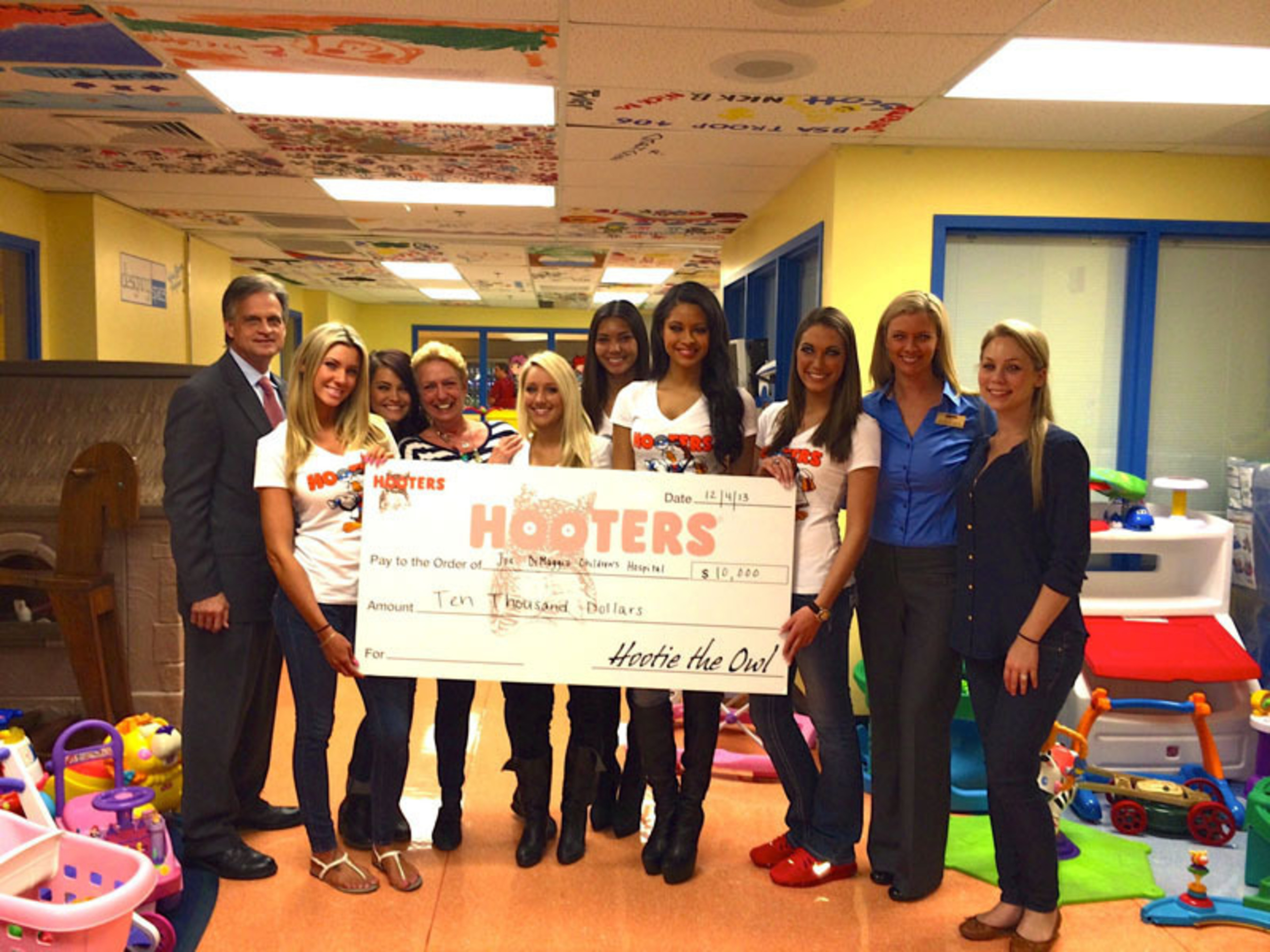 Hooters of South Florida Makes a $10,000 donation to the Joe DiMaagio Children's Hospital. From Left to Right: Kevin Janser, Jenn Burkell, Ashley Tice, Karen Renzer, Kendall Lanese, Kathy Diehl, Marissa Raisor, Alyssa Wickman, Krisit Quarles and Lauren Haywood. (PRNewsFoto/Hooters of South Florida) (PRNewsFoto/HOOTERS OF SOUTH FLORIDA)