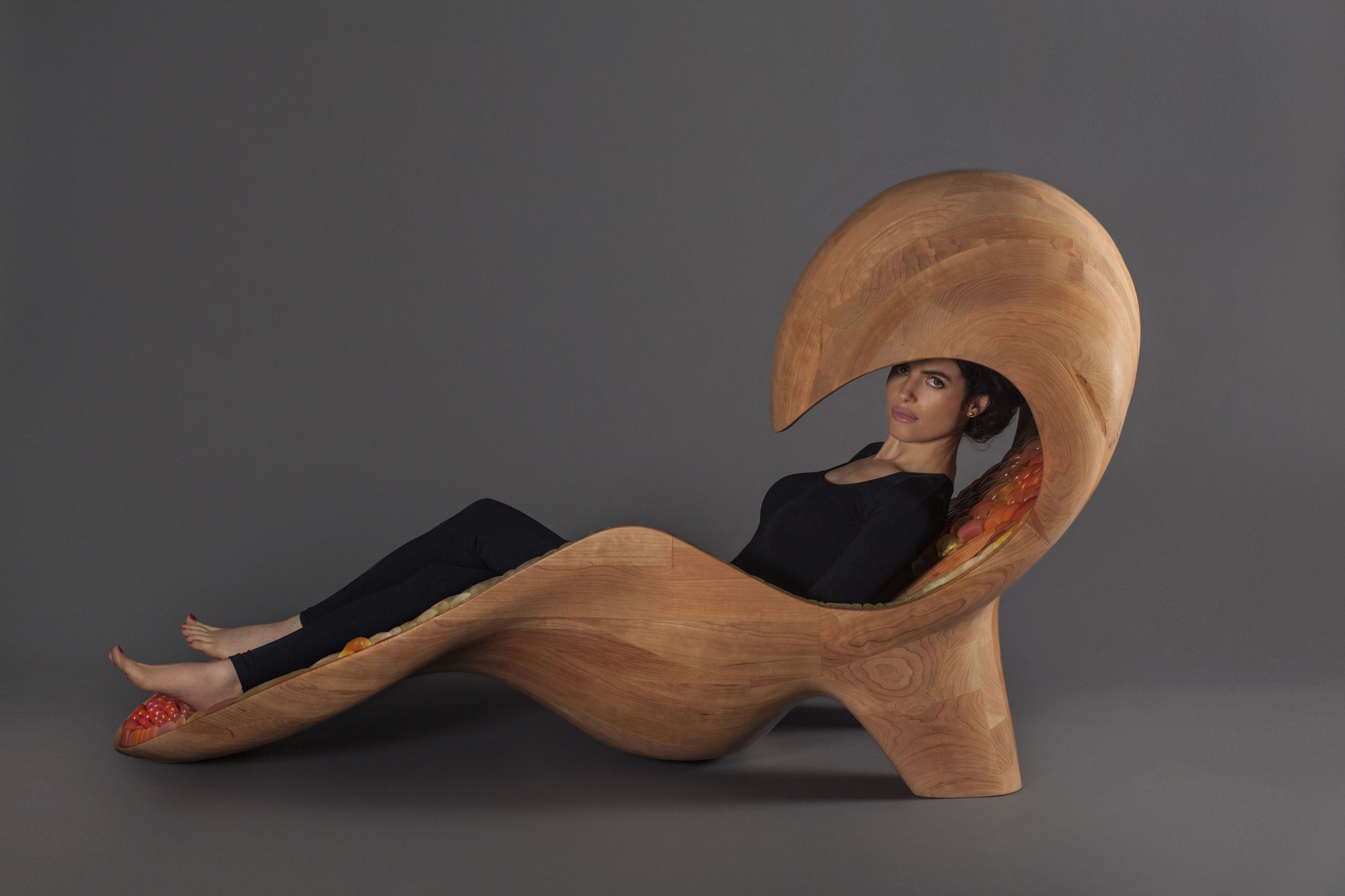Professor Neri Oxman reclining in her Gemini acoustic chaise featuring traditional and Stratasys additive manufacturing techniques (PRNewsFoto/Stratasys)
