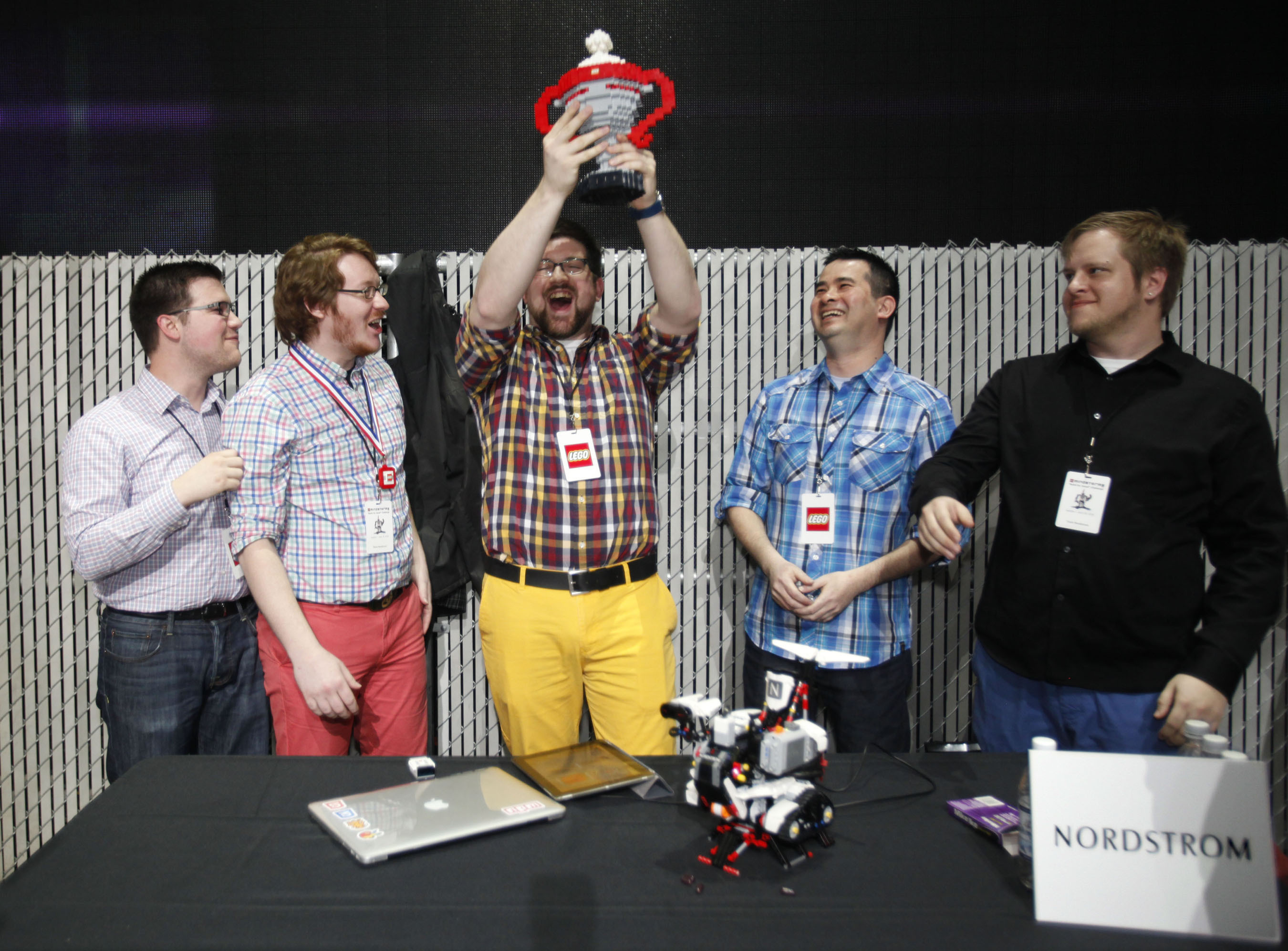 The Nordstrom team accepts the trophy for best LEGO MINDSTORMS EV3 robot during the "Build 4 Good" challenge at Seattle's EMP Museum on Thursday, April 10 2014. Local companies including Amazon, Egencia, Expedia, HTC, Nordstrom, Xbox and zulily built robots that celebrated creative solutions to everyday problems. (PRNewsFoto/LEGO Systems, Inc./Ron Wurzer/AP Images for The LEGO Group) (PRNewsFoto/LEGO SYSTEMS_ INC_)