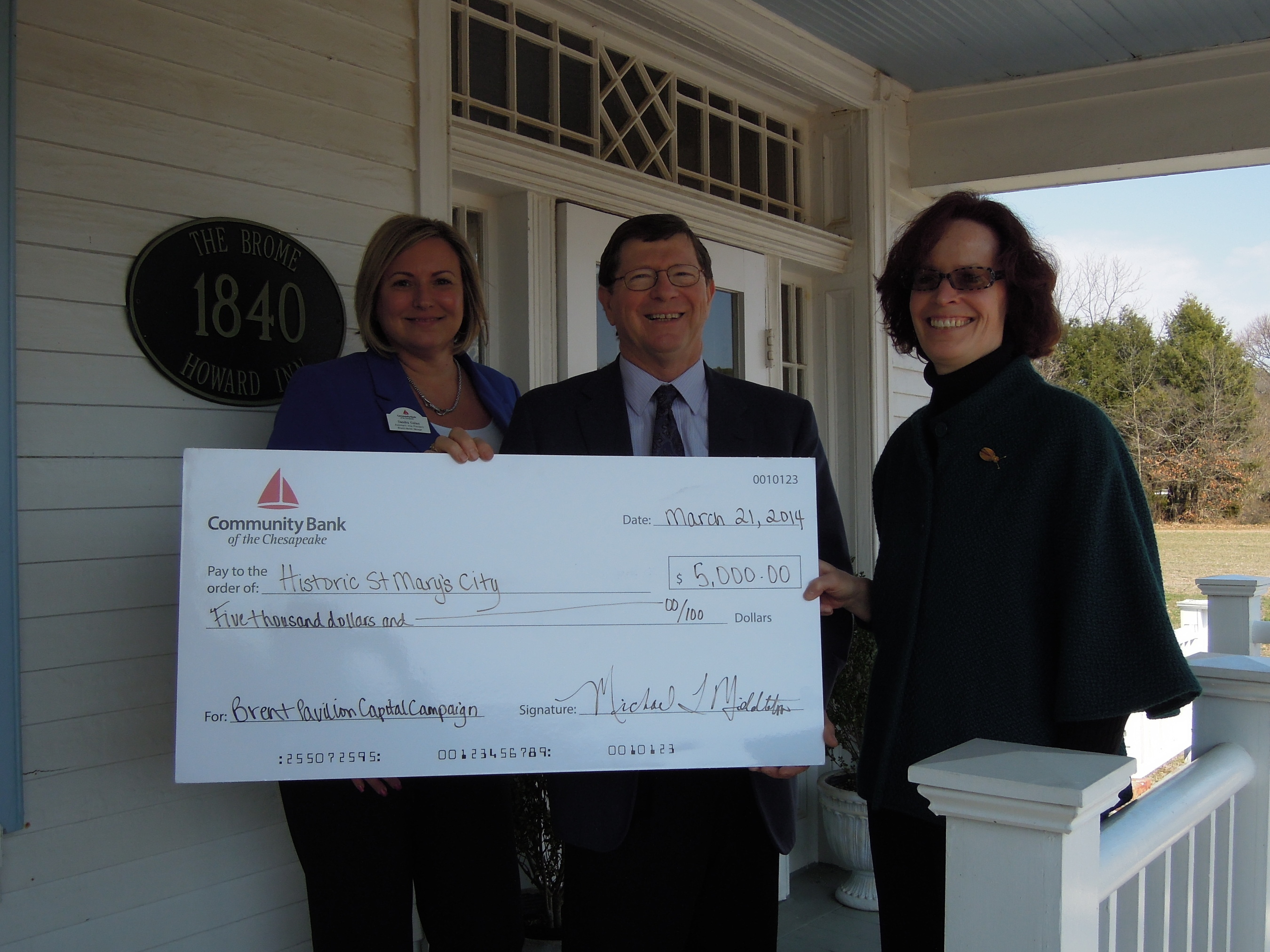 From left to right: Community Bank representatives Sandy Galan, Branch Market Manager, St. Mary's County and Michael Middleton, Chief Executive Officer, present donation check to Regina M. Faden, Executive Director of Historic St. Mary's City. (PRNewsFoto/Community Bank of the Chesapeake)