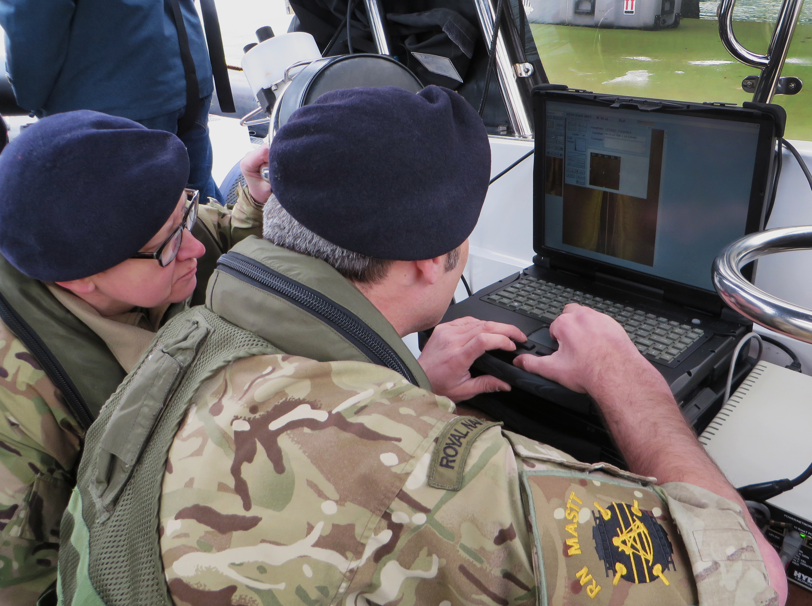 Royal Navy MASTT officers review side scan data (PRNewsFoto/Hydroid, Inc.)