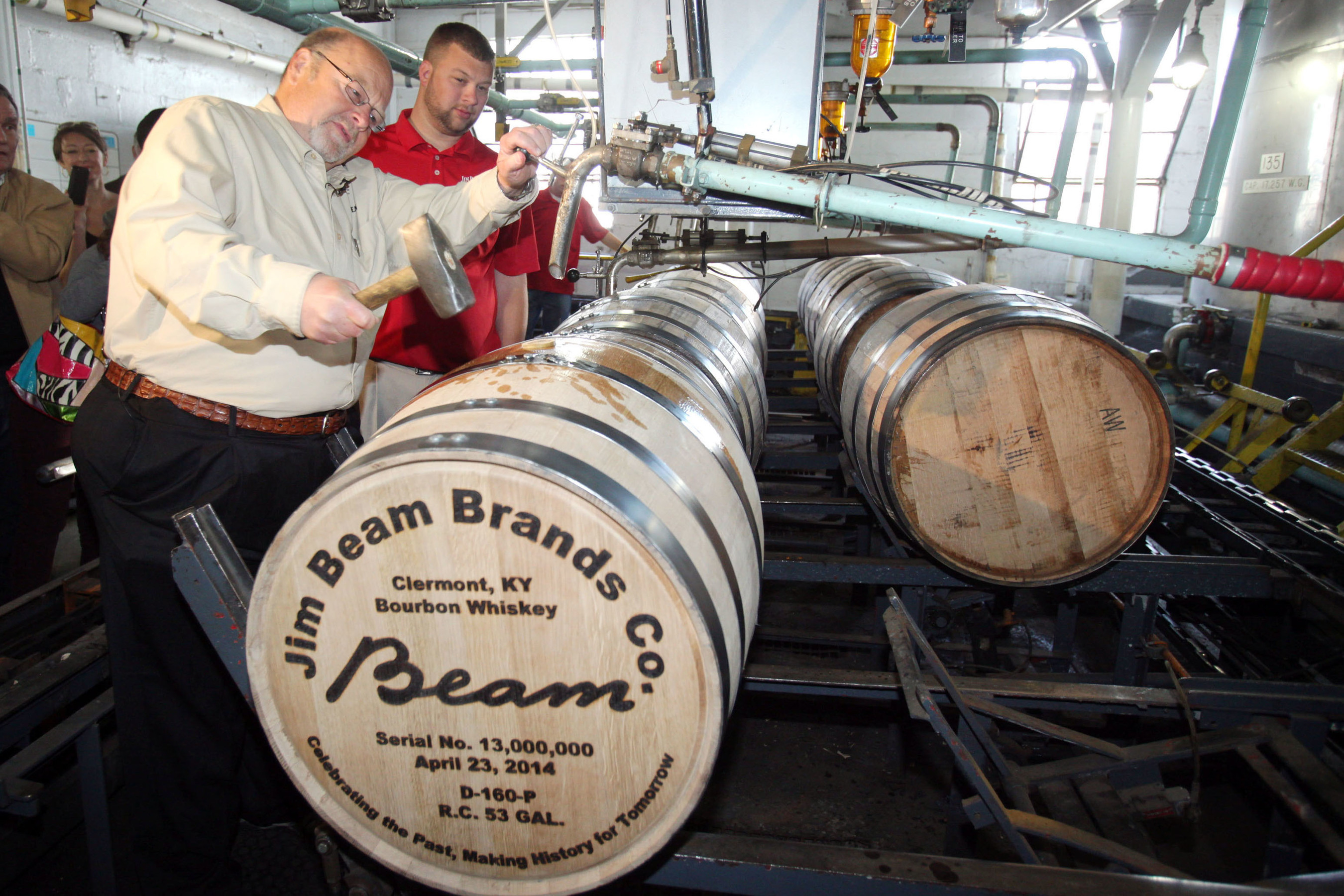 Fred Noe, Jim Beam's great-grandson and seventh generation master distiller for Jim Beam(R) Bourbon, hammers the bung into the company's historic 13 millionth barrel, filled April 23, 2014, in the cistern room on the grounds of the company's flagship distillery in Clermont, Ky. Noe was joined by his son, Freddie Noe, an eight generation Beam, who hammered in the final seal before the barrel was sent to age in the distillery's historic rackhouse D. (PRNewsFoto/Beam Inc.)