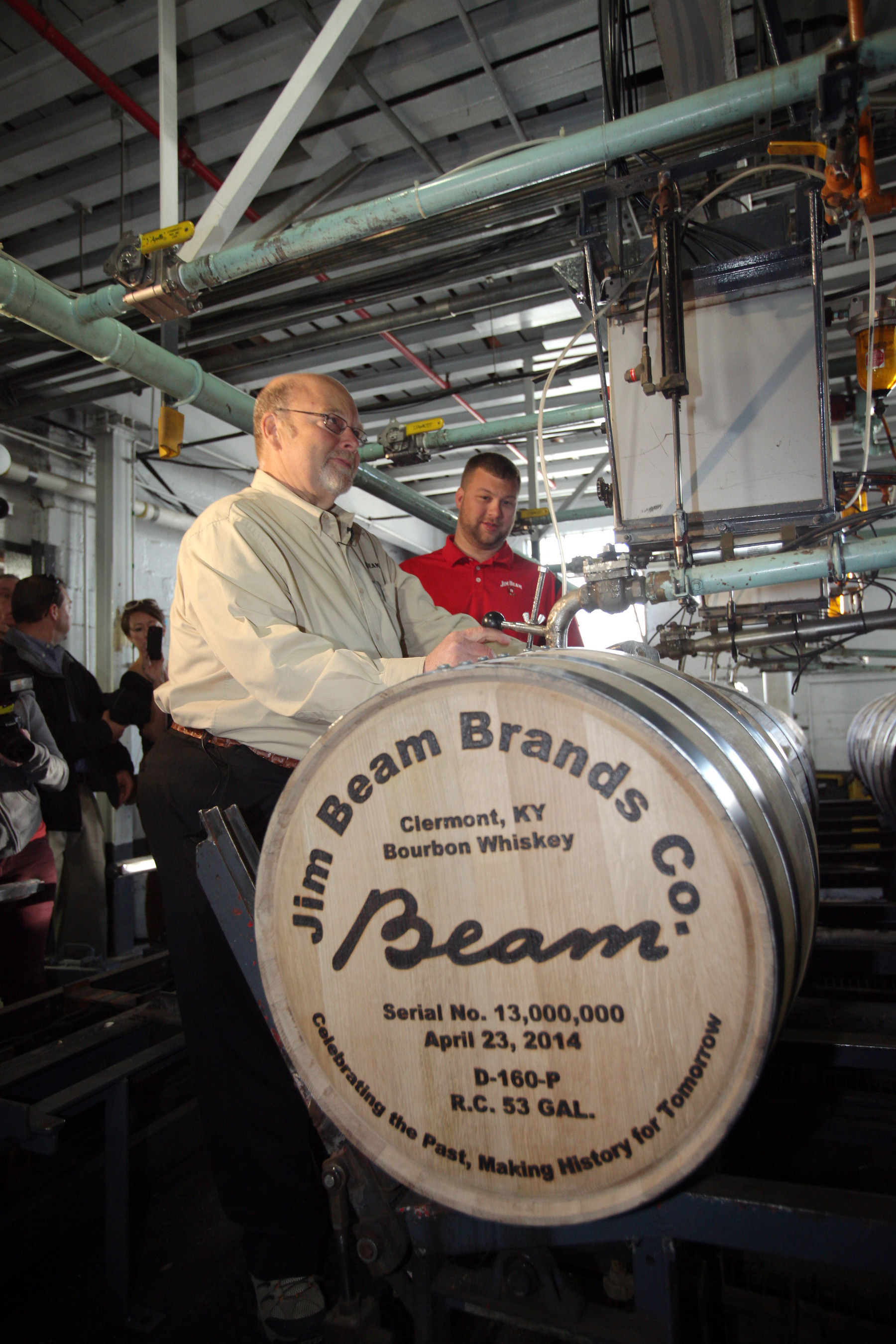 Jim Beam(R) Bourbon made history April 23, 2014, by filling its 13 millionth barrel of bourbon since Prohibition - an industry first. Fred Noe, Jim Beam's great-grandson and seventh generation master distiller, was joined by his son, Freddie Noe, an eight generation Beam at the company's flagship distillery in Clermont, Ky., for the milestone event.  (PRNewsFoto/Beam Inc.)
