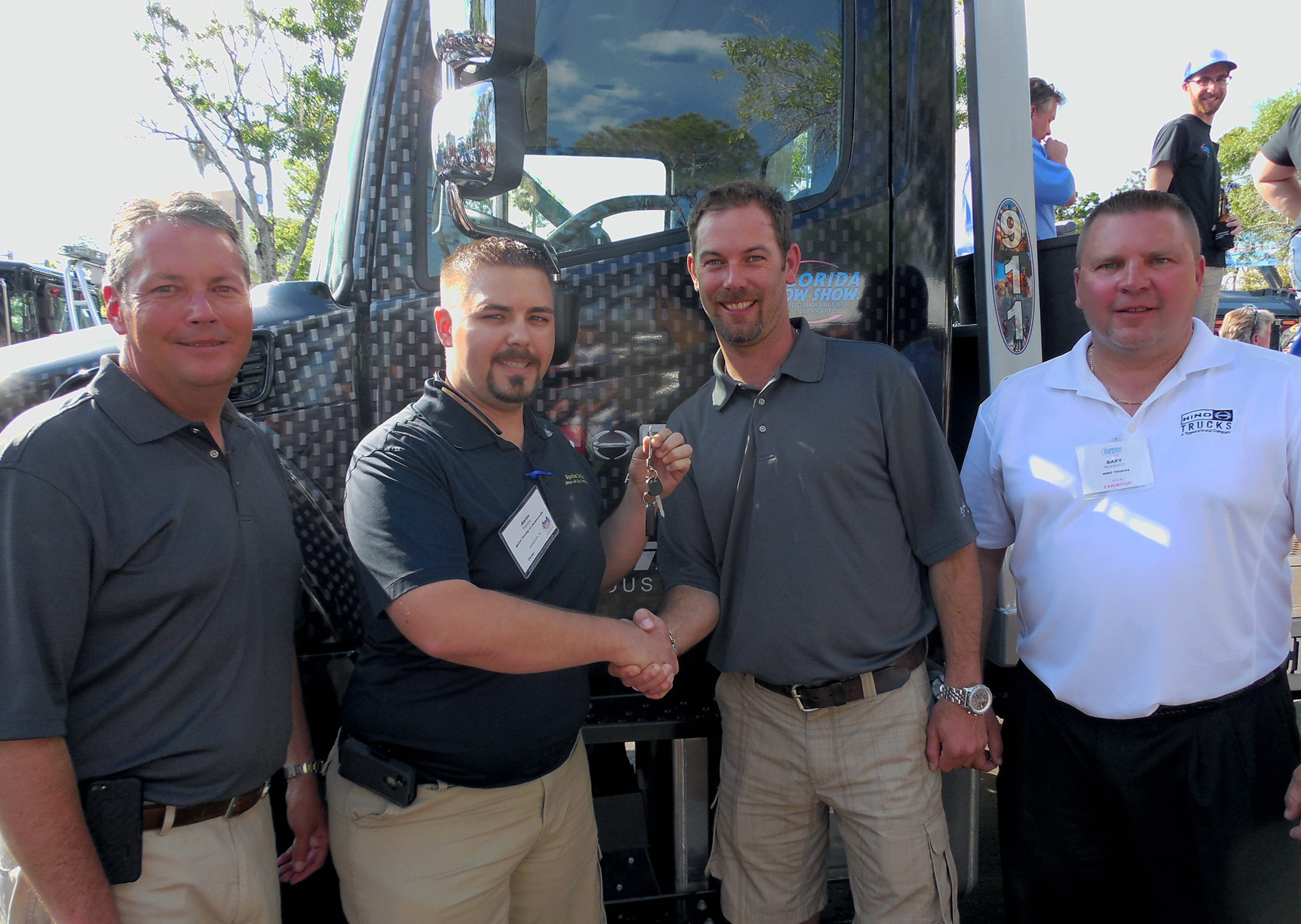 Pictured from left: Vince Tiano, Vice President of Miller Industries; Aaron Forron; Will Miller, President and Co-CEO of Miller Industries; and Gary Mickiewicz, Vice President, Eastern Region of Hino Trucks. (PRNewsFoto/Hino Trucks )