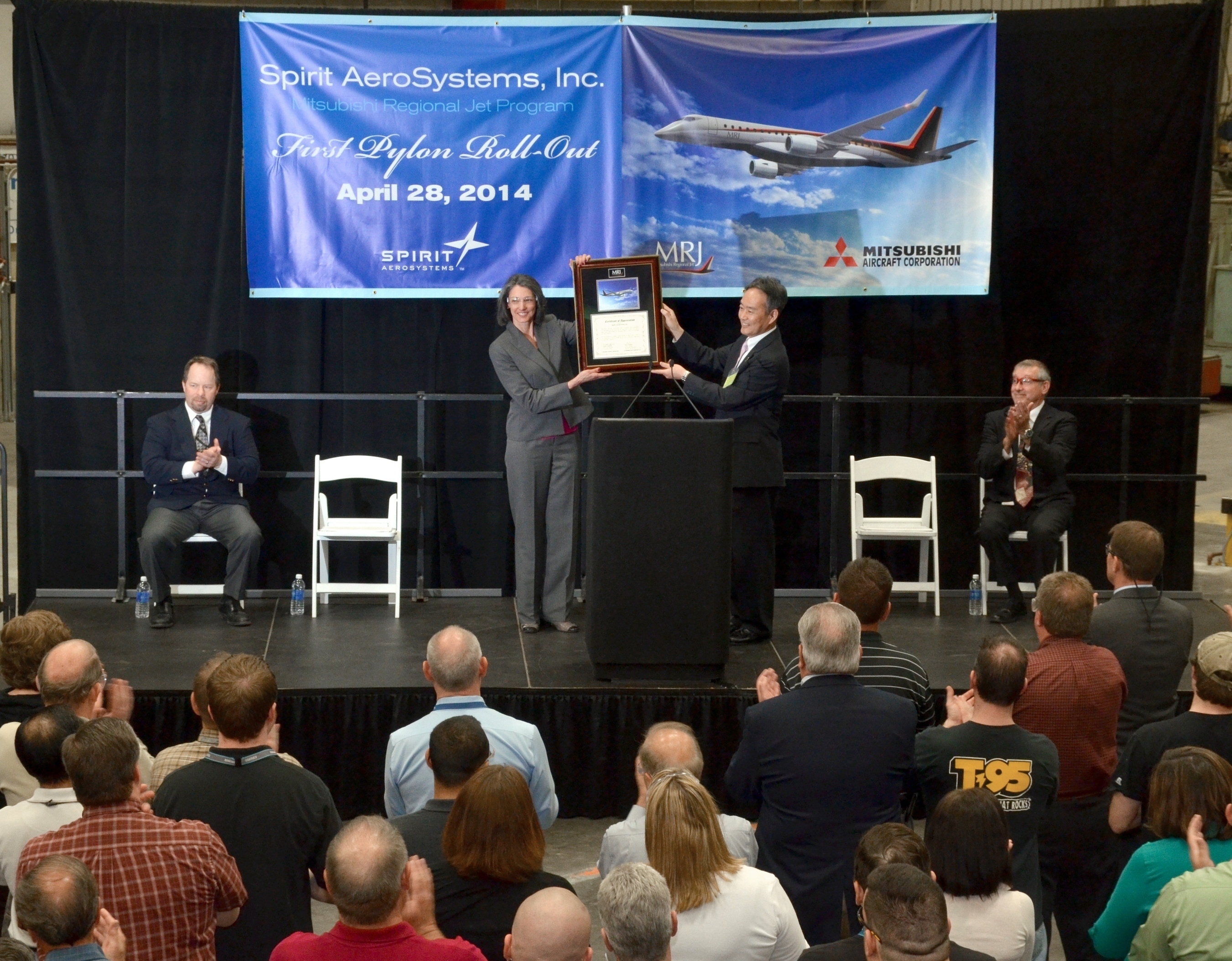 Vice President of Supply Chain for Mitsubishi Aircraft, Fujimori-san, presents a plaque to Spirit AeroSystems Director of Business & Regional Jet programs, Cathy McClain at a celebration marking the delivery of the first test flight pylon for the Mitsubishi Regional Jet. (PRNewsFoto/Spirit AeroSystems, Inc.) (PRNewsFoto/Spirit AeroSystems, Inc.)