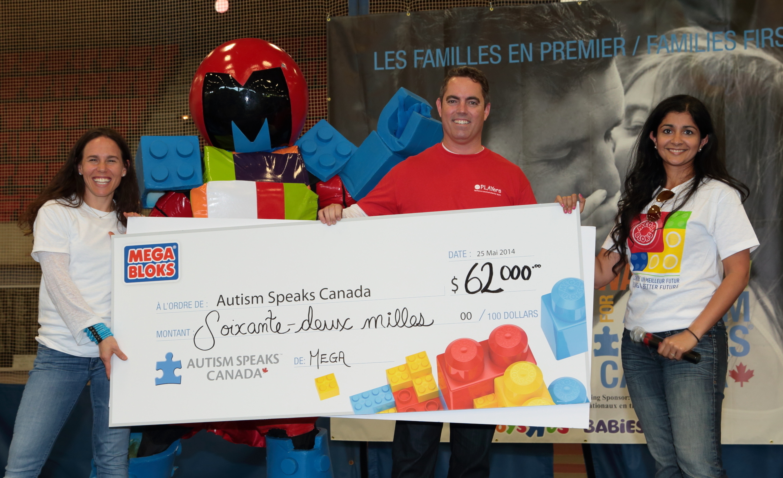 Executive Director of Autism Speaks Canada, Jill Farber, (left) accepts a donation from Robert Goodwin, Executive Director of the Mattel Children's Foundation, and Bisma Ansari, Vice President of Marketing at MEGA Brands Inc., at the Montreal Walk Now for Autism Speaks Canada fundraising event on May 25, 2014. (PRNewsFoto/MEGA Brands Inc.)