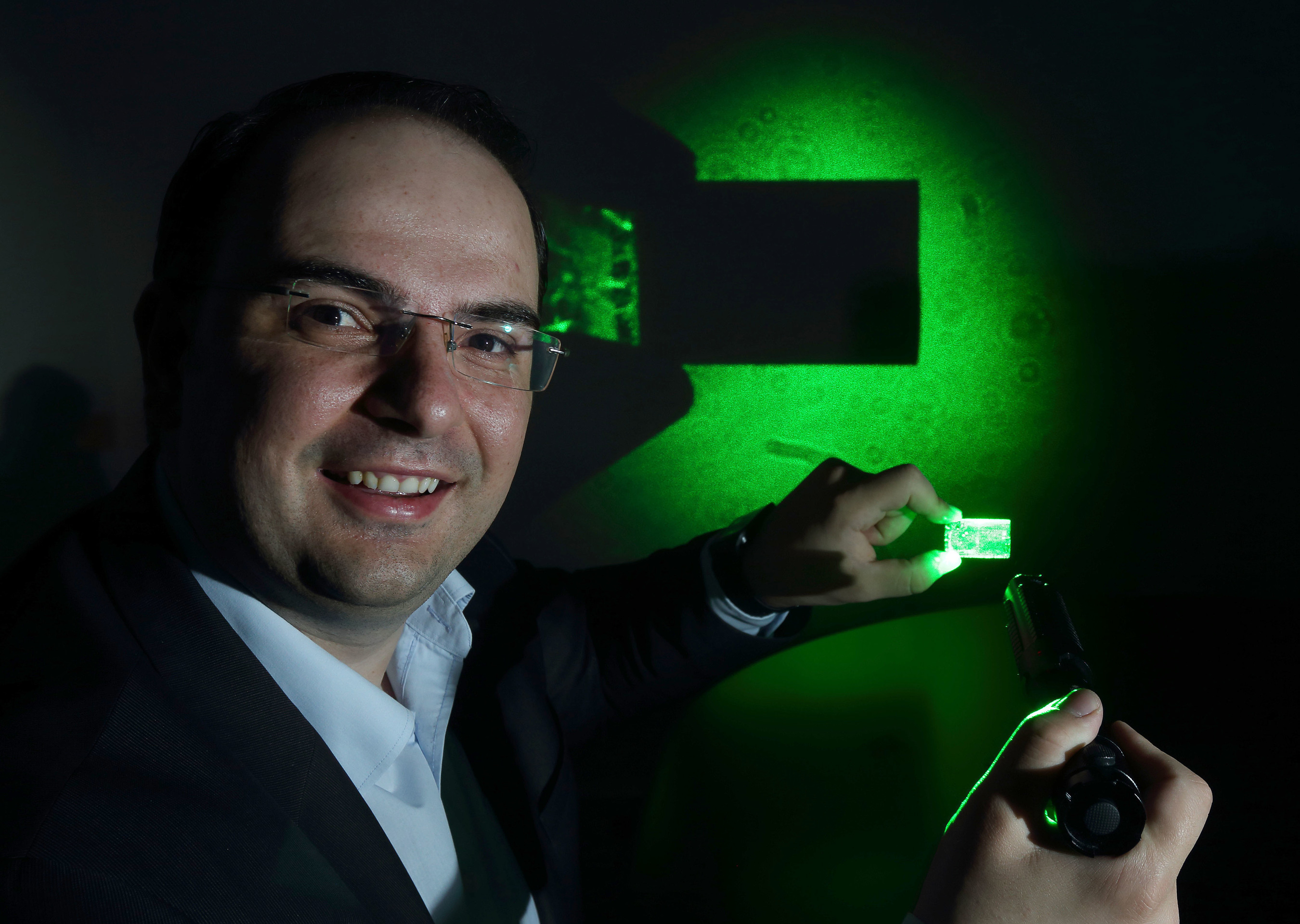 George Palikaras, President and CEO Lamda Guard demonstrates the effectiveness of his uniquely transparent yet 100% deflective nanocomposite windshield film at the announcement of the company's partnership with leading aircraft manufacturer Airbus. The film has the capacity to disable cockpit laser strikes. (PRNewsFoto/Lamda Guard)