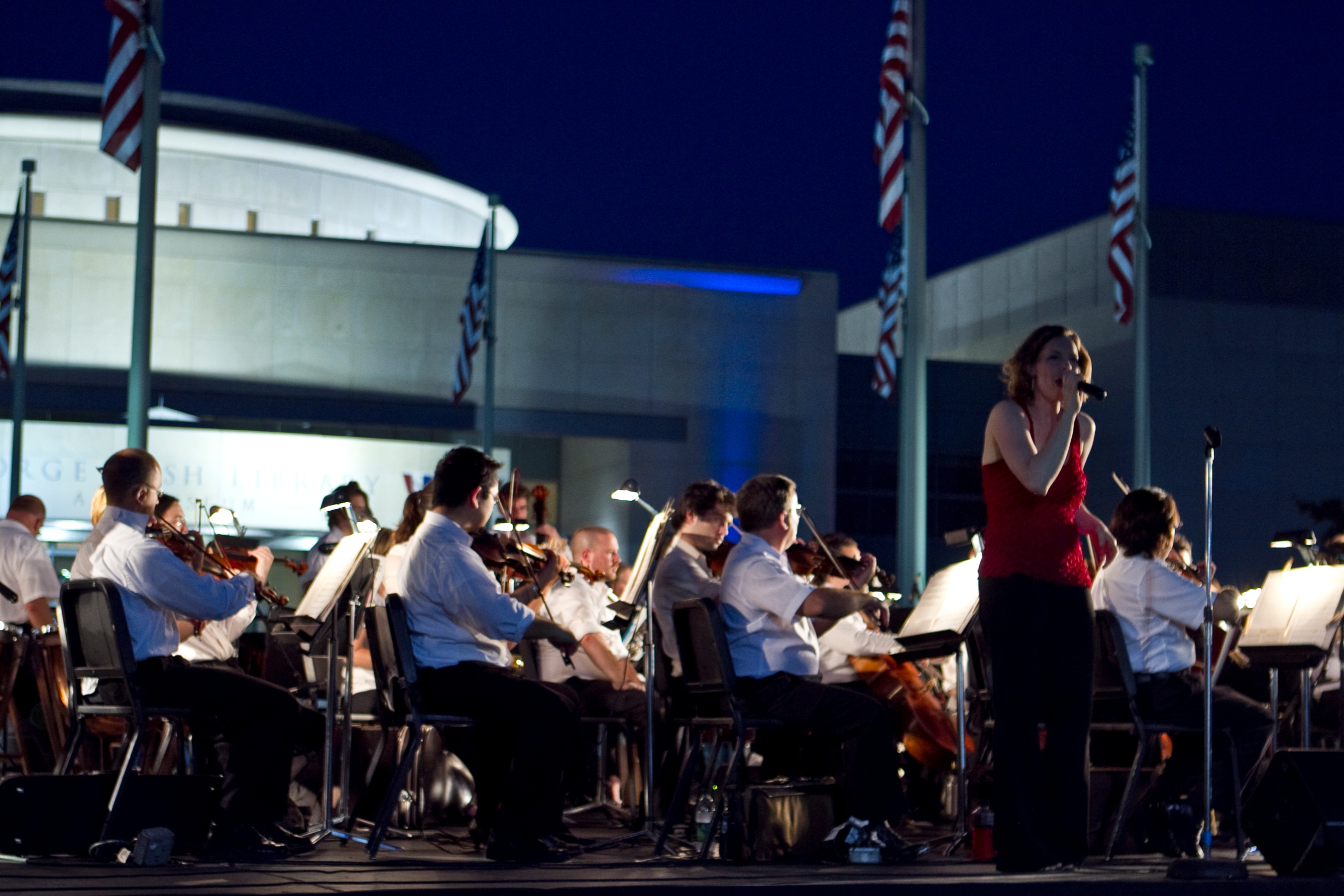 The Brazos Valley Symphony Orchestra and Kelsey Taylor perform the national anthem at the College Station Noon Lions Club's "I Love America" Celebration at the George Bush Presidential Library and Museum, July 4, 2011. (PRNewsFoto/George Bush Presidential Library)