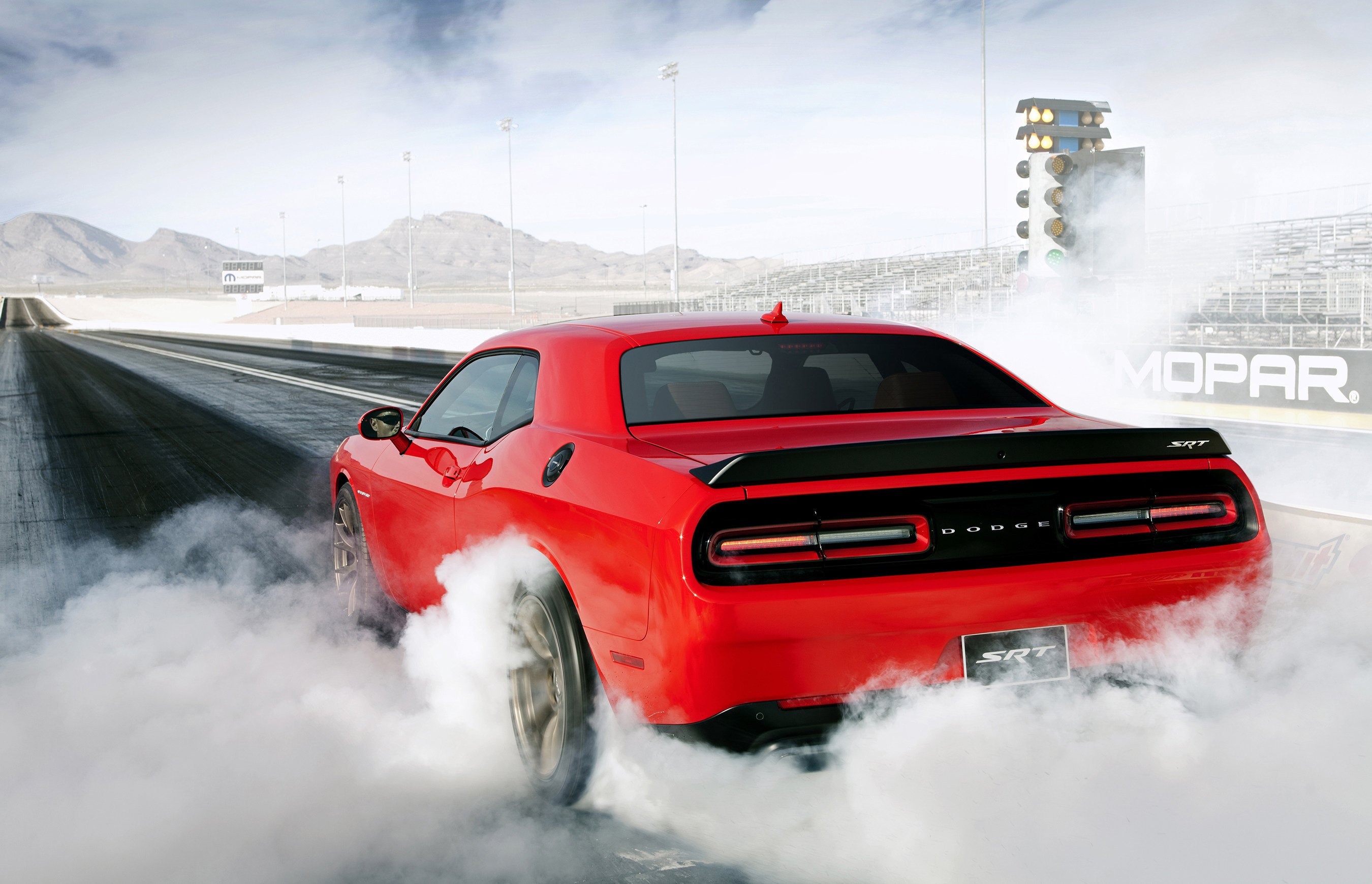 The 2015 Dodge Challenger SRT Hellcat is the fastest muscle car ever with a National Hot Rod Association-certified 1/4-mile elapsed time of 11.2 seconds at 125 miles per hour (mph) with stock Pirelli P275/40ZR20 P Zero tires. With drag radials, the run dropped to just 10.8 seconds at 126 mph!  The Dodge Challenger SRT Hellcat is also the most powerful muscle car ever with an unprecedented 707 horsepower and 650 lb.-ft. of torque. (PRNewsFoto/Chrysler Group LLC)