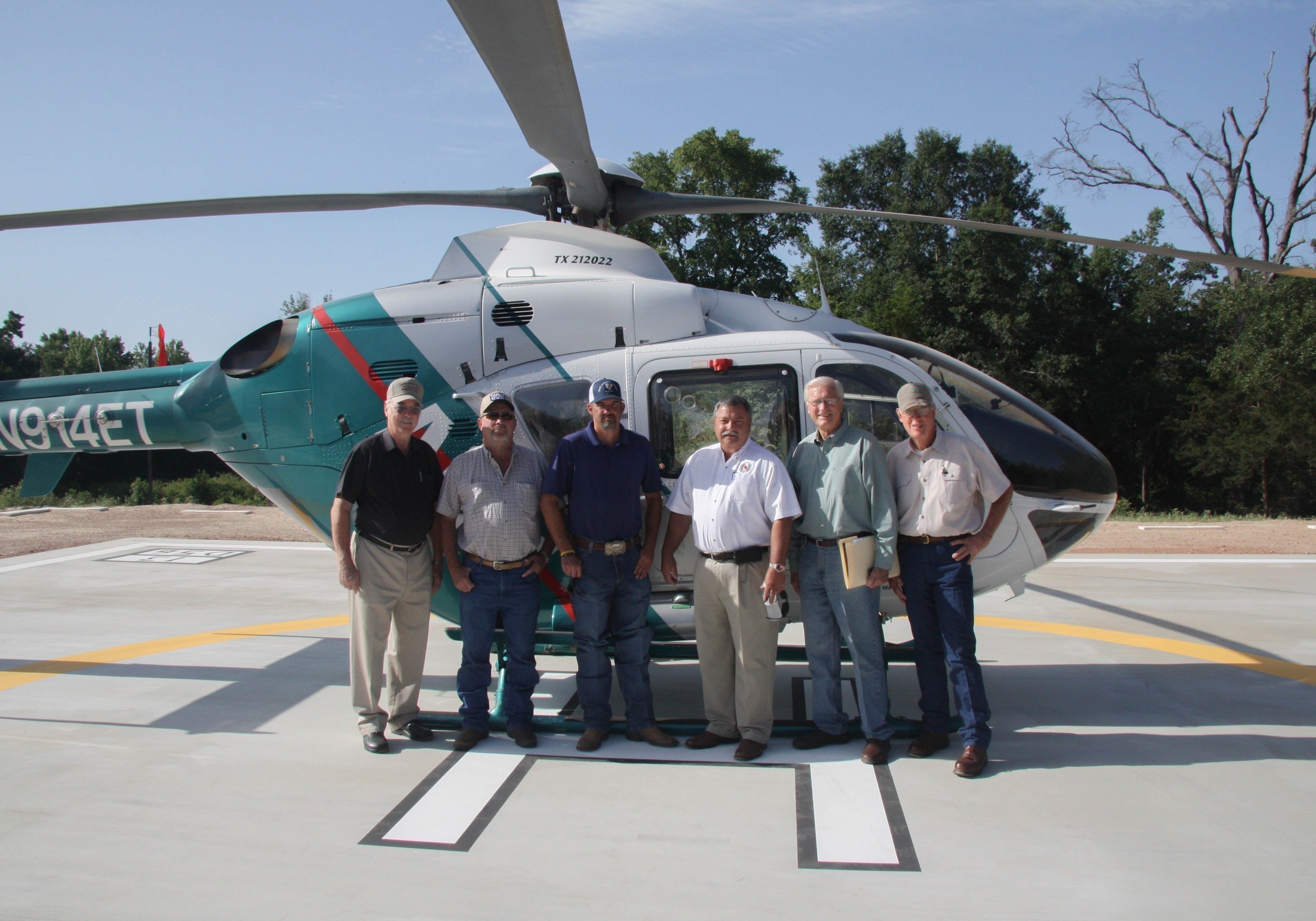 Photo of community leaders at new Anderson County heliport: (Left to right) David Lang, Director of Trinity Valley Electric; Bob Sheppler, Anderson County rancher and contractor; Anderson County Commissioner Joey Hill; Anderson County Judge Robert Johnston; Anderson County Airport Zoning Commission Chairman Elton Bomer; and Airport Zoning Commissioner Bob Hill. (PRNewsFoto/Bradley Oaks Ranch)
