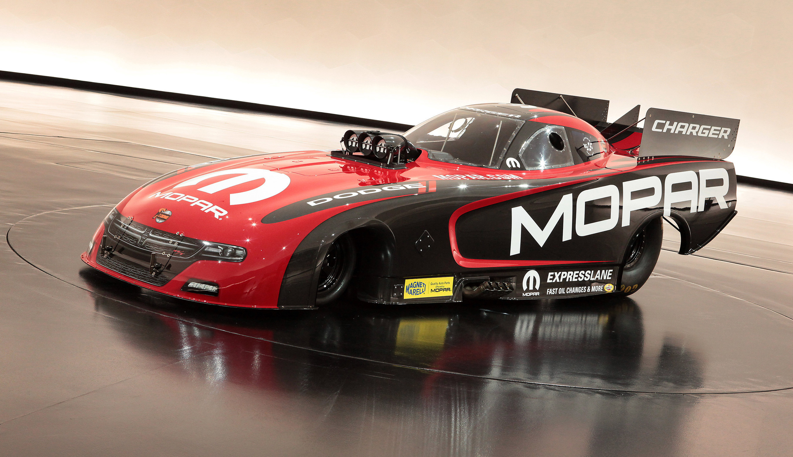 A new 2015 Mopar Dodge Charger R/T Funny Car drag racing vehicle unveiled at the SEMA.