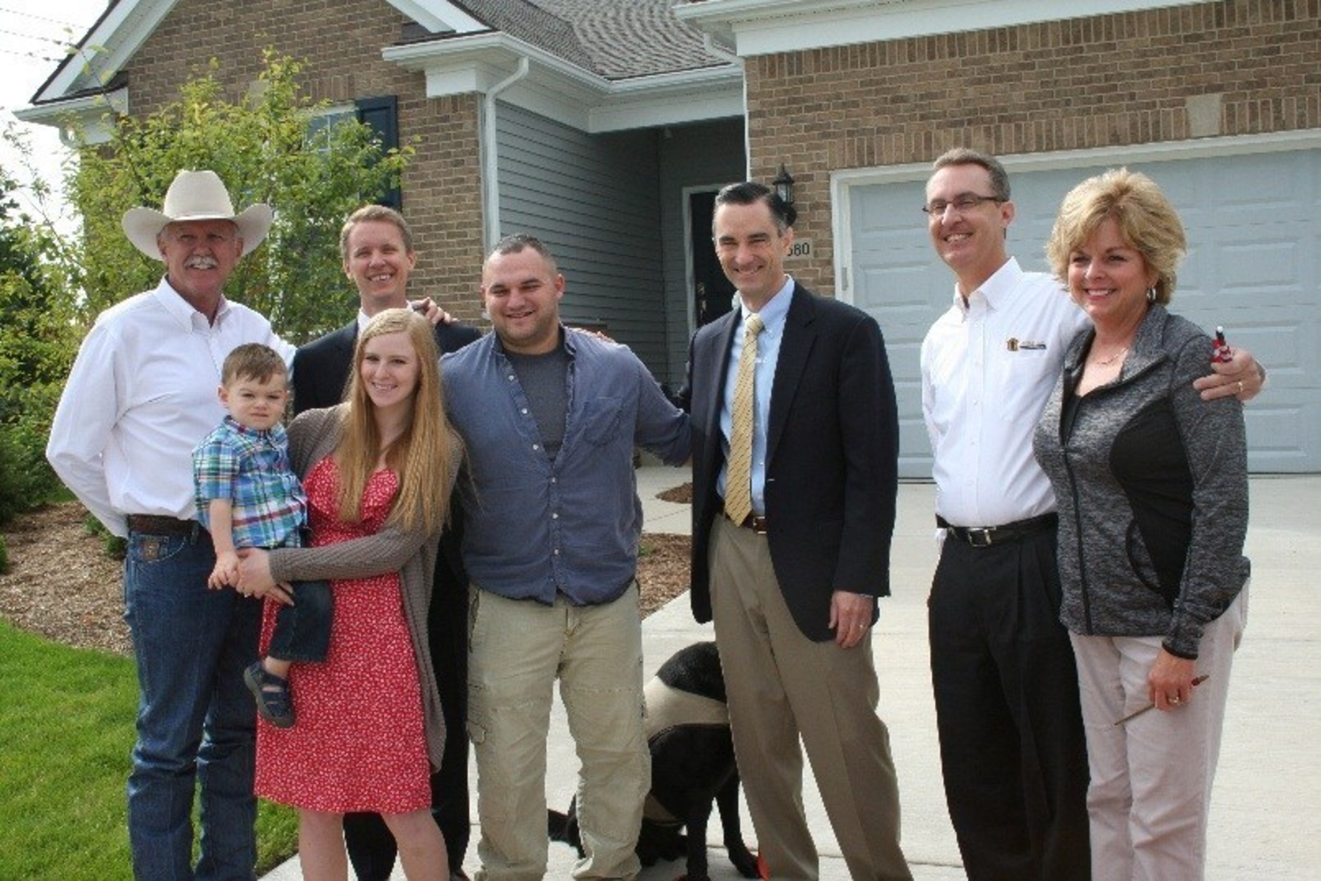 PulteGroup CEO Richard Dugas (3rd from right) at a home delivery in Michigan, one of 20 Built to Honor homes to be gift to deserving veterans and their families in 2014.