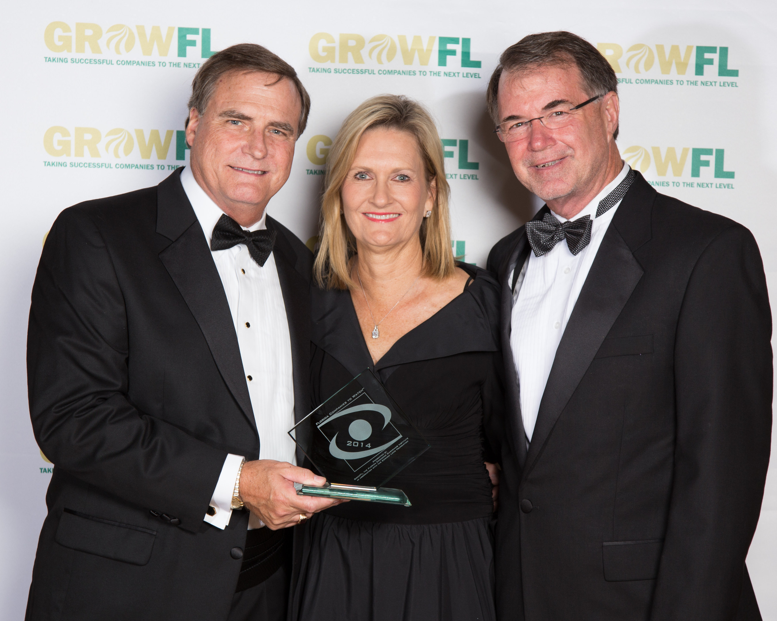 Employment Technologies founders Joseph and Eugenia Sefcik (left and center) proudly accept the Florida Companies to Watch Award from Dr. Tom O'Neal, Executive Director of GrowFL (right).