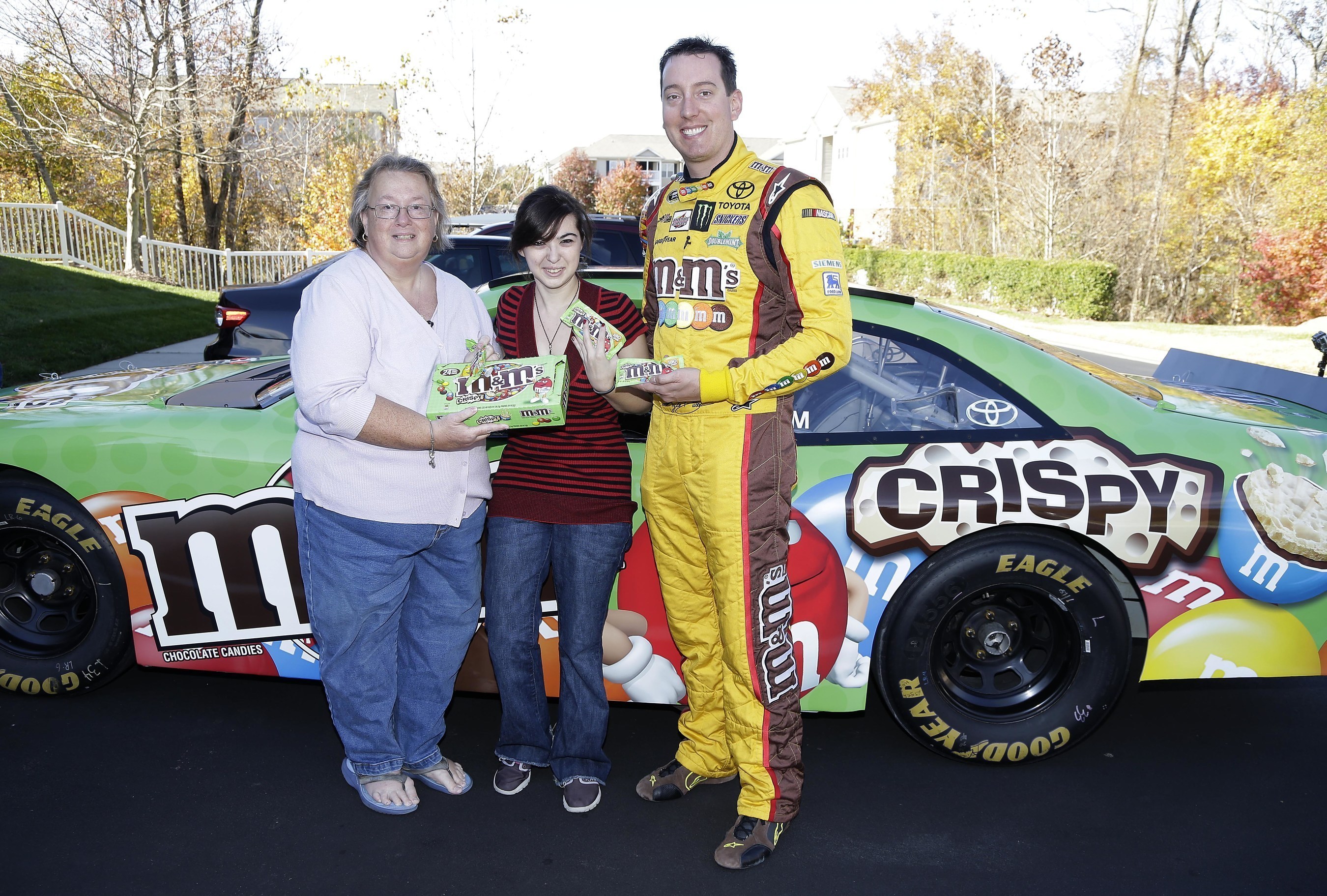 M&M'S(R) Racing driver Kyle Busch, right, makes a speedy delivery of new M&M'S Crispy to super fan Rose Abbate at her home in Charlotte, NC in response to a plea she made on the brand's Facebook page. The delivery is the just the latest example of how the M&M'S(R) Brand is listening and engaging with fans of M&M'S(R) Crispy even before the product officially returns to stores in January after a 10-year hiatus.