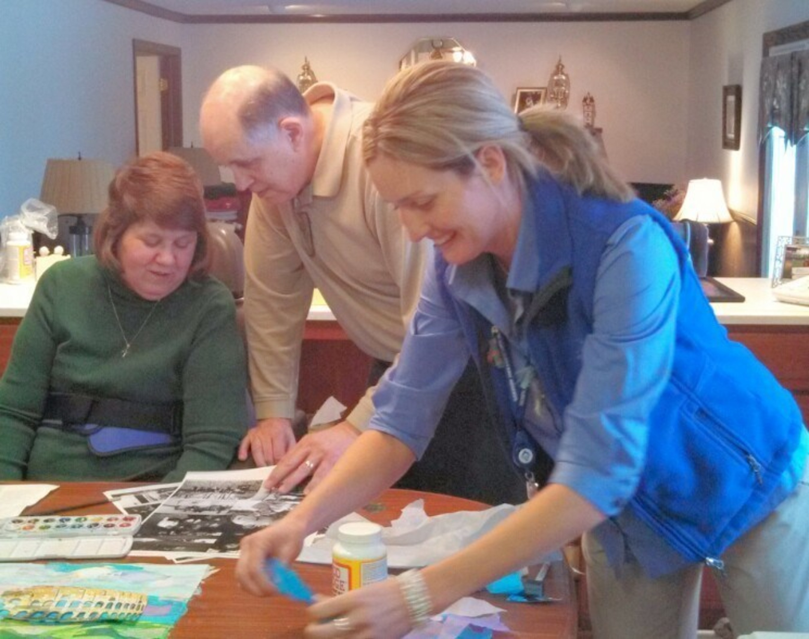 Michele and her husband, Joe, work on a collage documenting an anniversary trip to Italy with the guidance of Hospice of the Western Reserve art therapist Holly Queen.