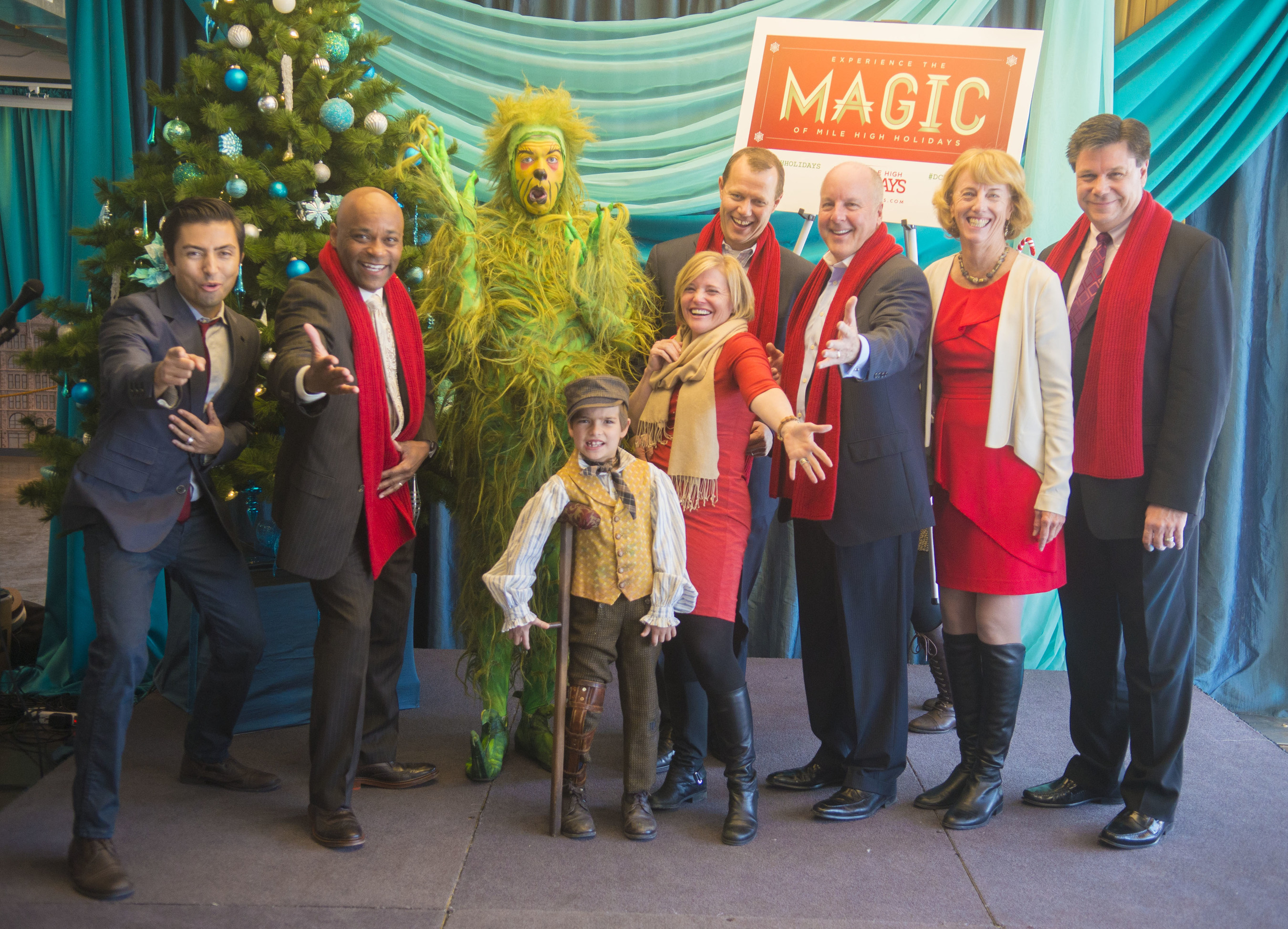 Mile High Holidays 2014 Press Conference: (From Left to Right) Shaun Taylor-Corbett (Frankie Valli, Jersey Boys), Mayor Michael B. Hancock, The Grinch (How The Grinch Stole Christmas! The Musical), Tiny Tim (A Christmas Carol), Tami Door (Downtown Denver Partnership), Dave Dixon (Cherry Creek Shopping Center), Richard Scharf (VISIT DENVER), Julie Underdahl (Cherry Creek North) and Jeff Hovorka (DCPA) at the Mile High Holidays 2014 Press Conference. Image courtesy of Evan Semon.