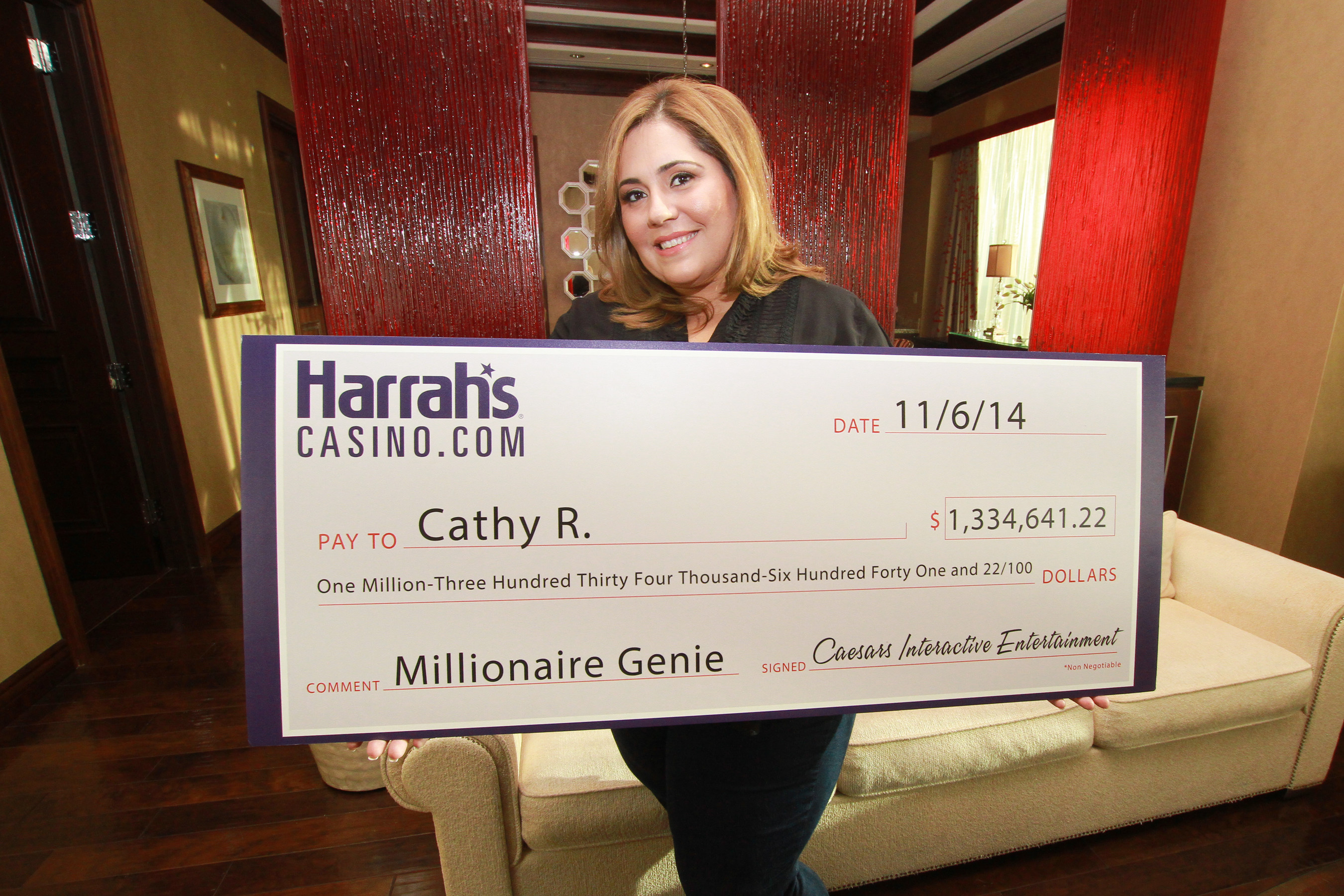 Cathy R. holds a ceremonial check at Harrah's Casino in Atlantic City after winning more than $1.3 million playing a HarrahsCasino.com slot game at her home on November 6.