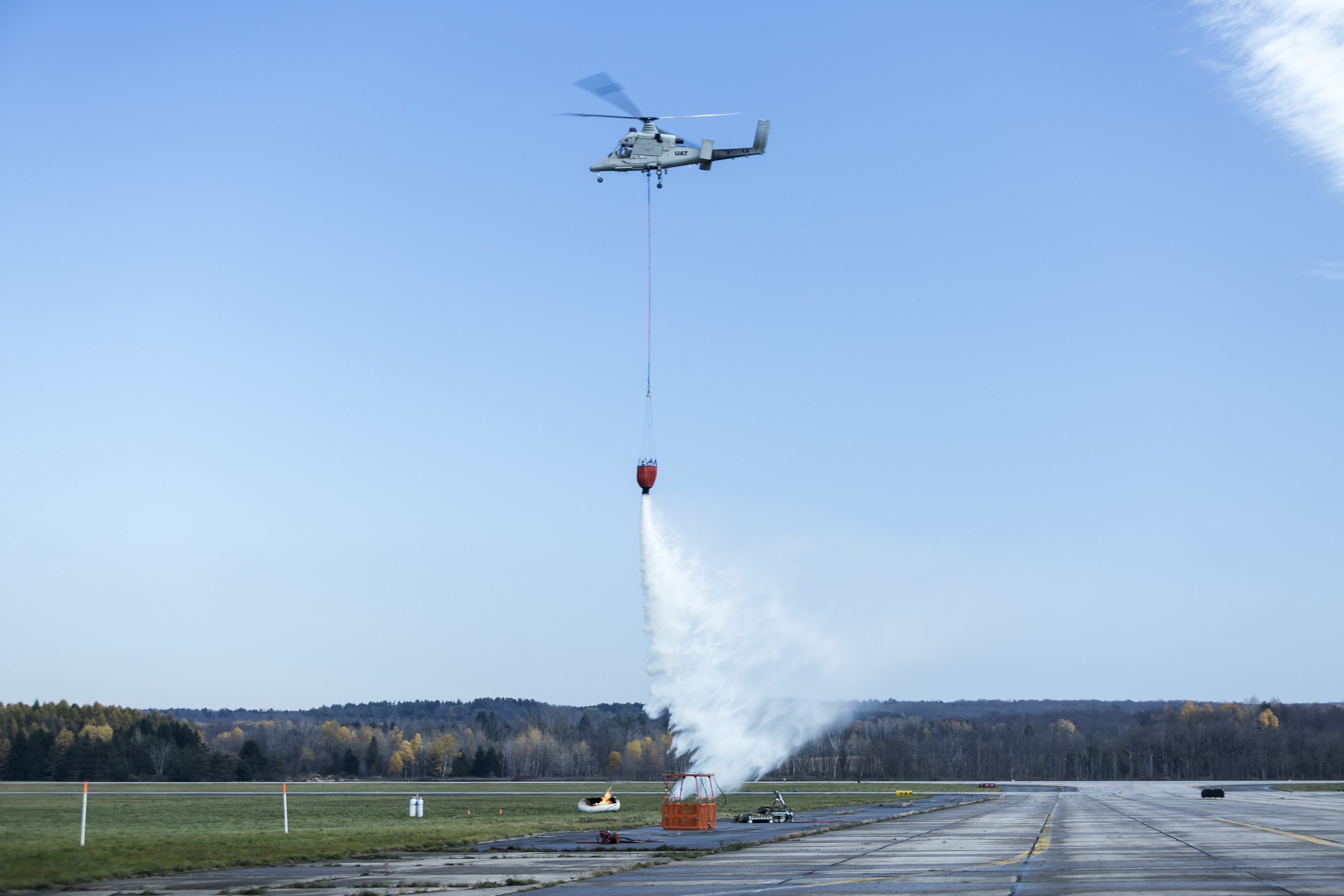 The unmanned K-MAX helicopter successfully conducted a firefighting mission during a demonstration on Nov. 6. Aided by the small unmanned Indago quad rotor, unmanned K-MAX extinguished several fires while collecting and dropping more than 24,000 pounds of water onto the flames in one hour.
