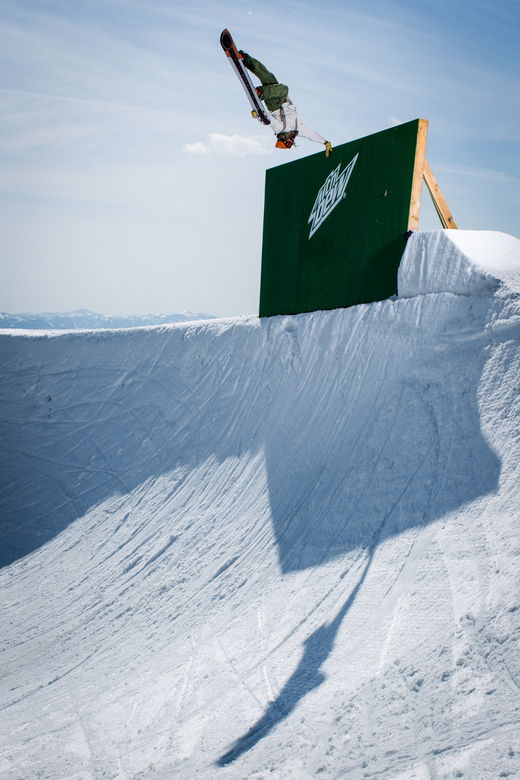 Danny Davis sticks a hand plant in the 22-foot deep bowl at #PeacePark14. This year's build out was co-created by Davis and his sponsors, Mountain Dew and Burton Snowboards, and featured in Wyoming's West Tetons at the Grand Targhee Resort. Photo Credit: Adam Moran
