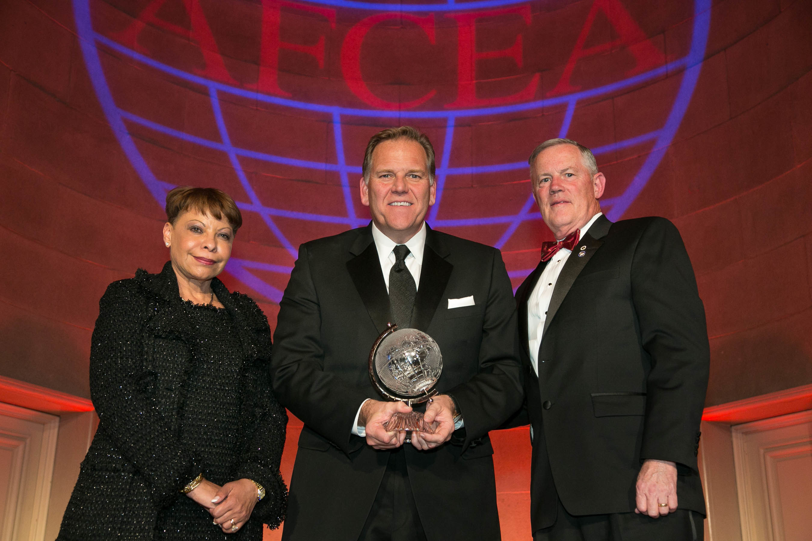 Rep. Michael J. Rogers (R-MI) (c), receives the 2014 AFCEA David Sarnoff Award from Lt. Gen. Robert M. Shea, USMC (Ret.) (r), president and chief executive officer, AFCEA International, and Linda Gooden, chair of the board, AFCEA International.