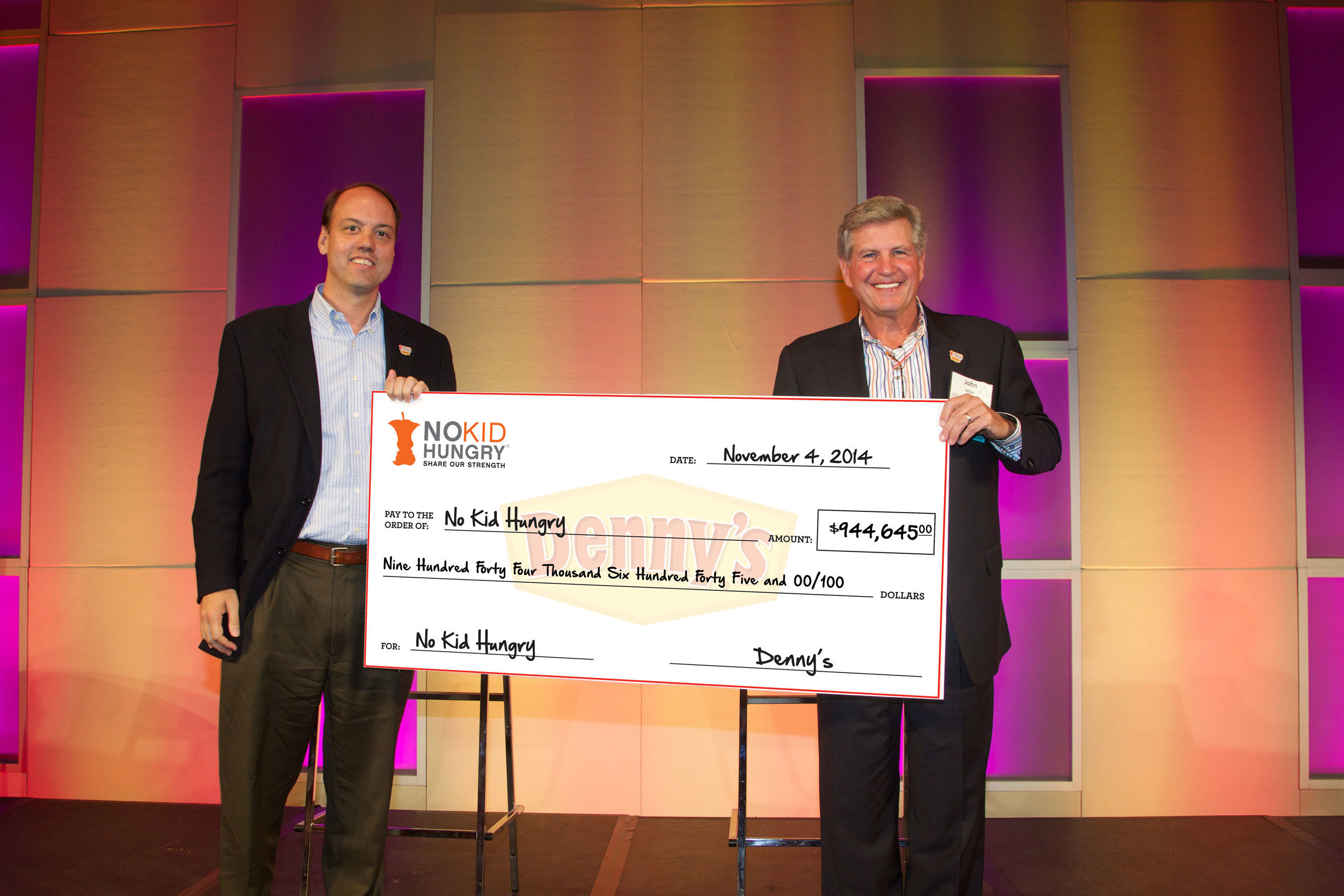 From L-R: Chuck Scofield, Chief Development Officer at Share Our Strength, receives a check from John Miller, Denny's Chief Executive Officer, as part of the diner's fourth annual fundraising efforts for Share Our Strength's No Kid Hungry(R) campaign