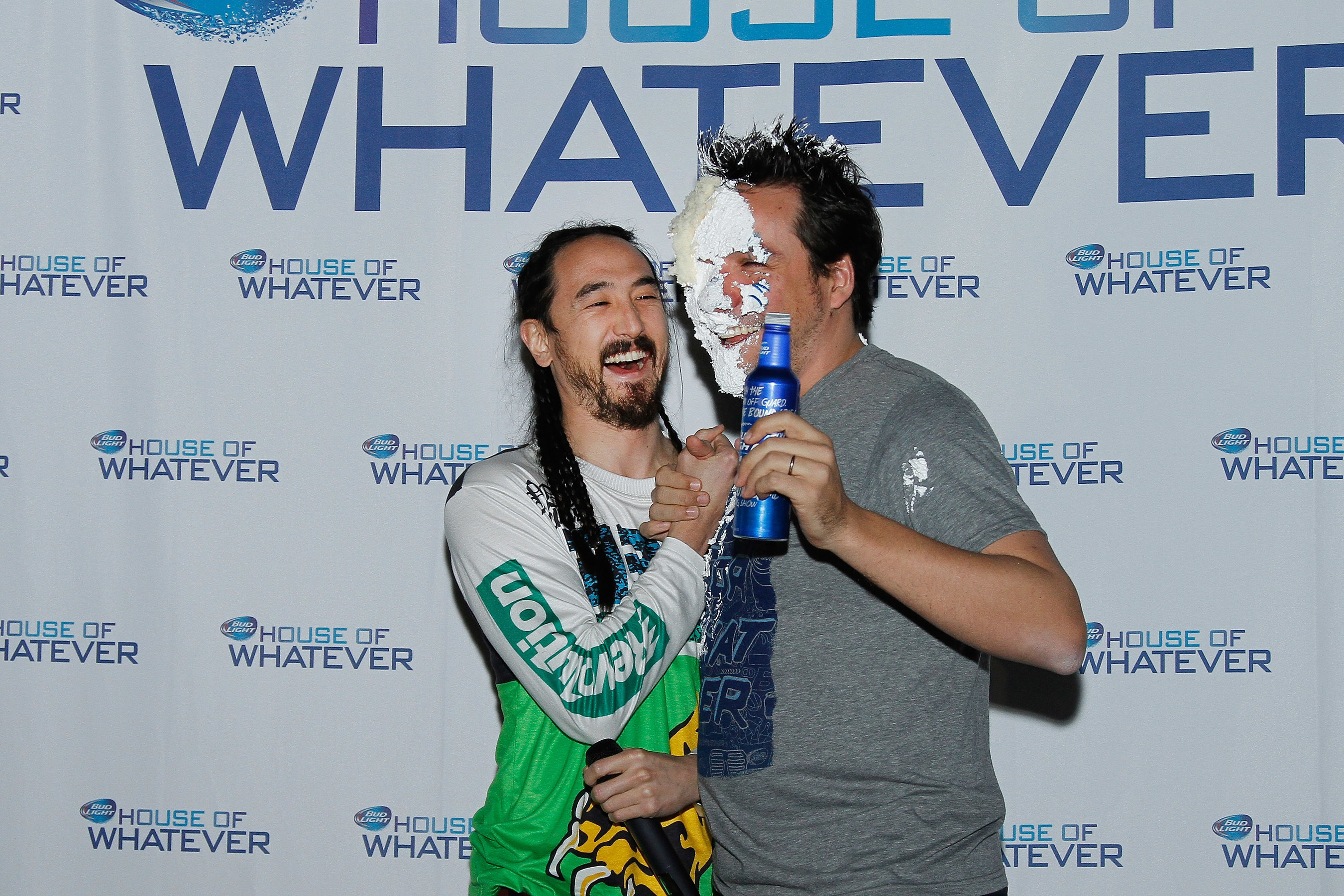 Grammy Award-nominated DJ Steve Aoki smashes cake into the face of Alex Lambrecht, vice president, Bud Light, during the brand's Bud Light House of Whatever unveil event in Phoenix, Ariz.