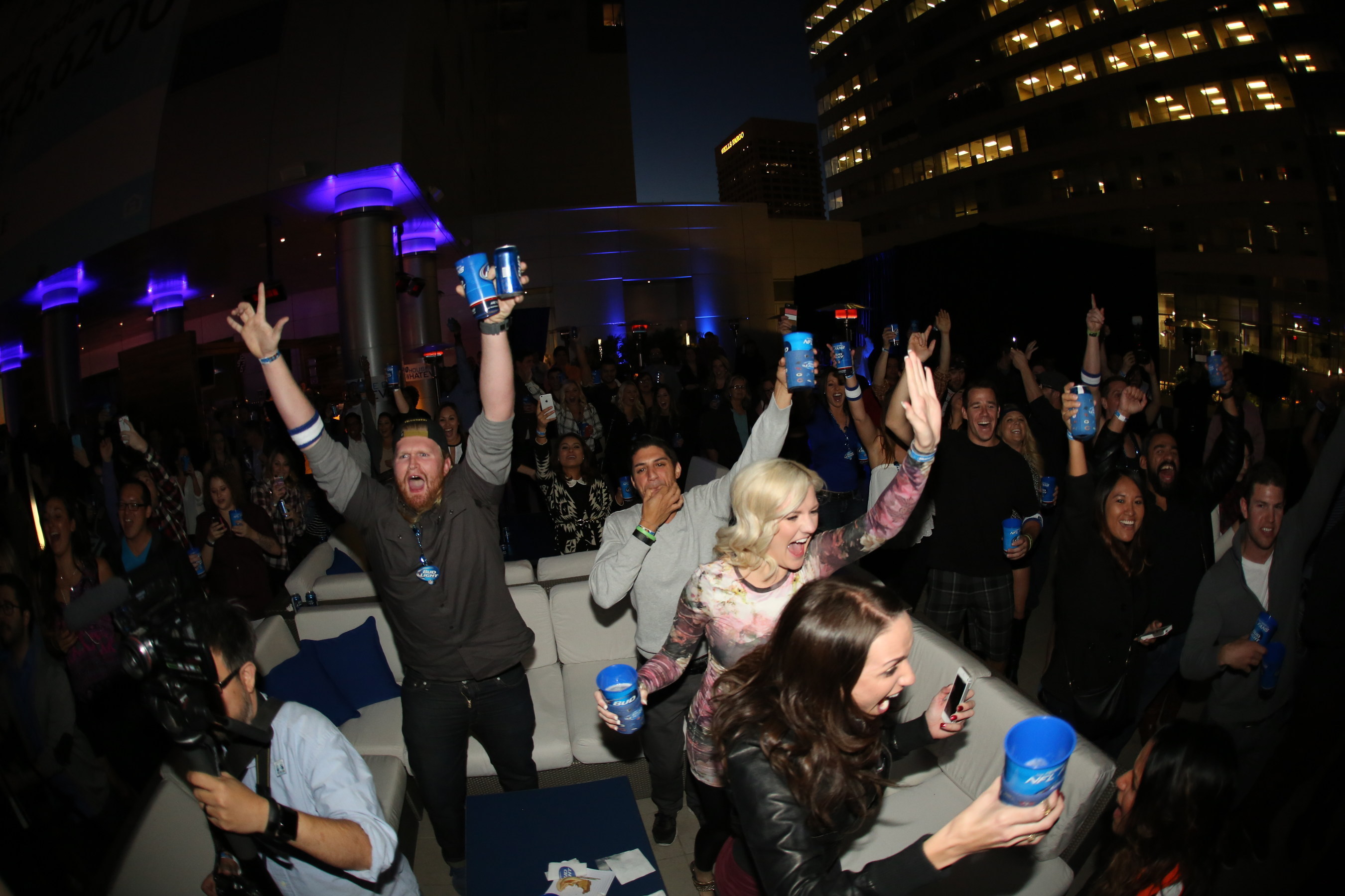 The crowd at Bud Light's Super Bowl XLIX unveil event in Phoeniz, Ariz. cheers after finding out they're all invited to the Steve Aoki's performance at Bud Light House of Whatever in January.