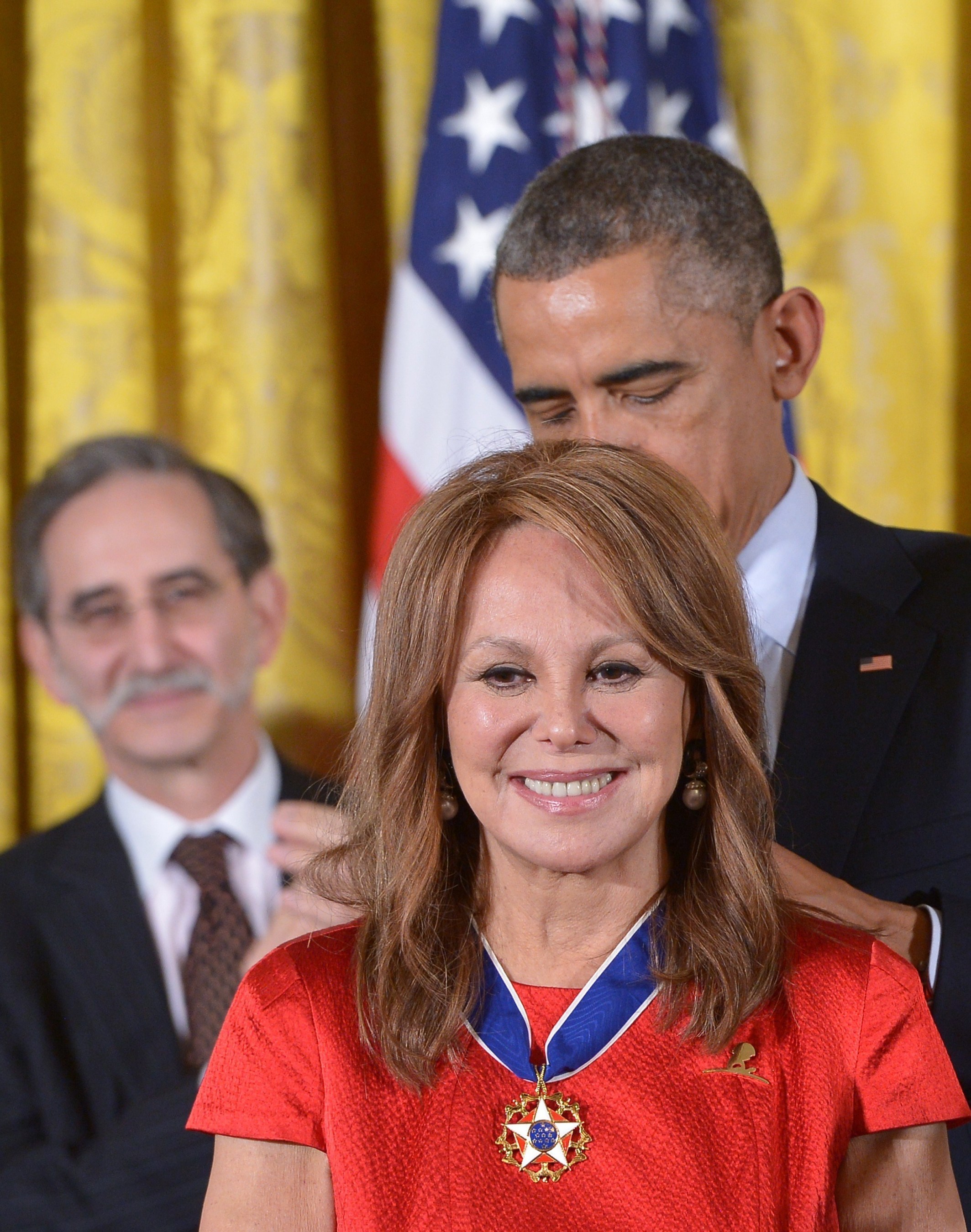 US President Barack Obama presents the Medal of Freedom to actress and St. Jude National Outreach Director Marlo Thomas during a ceremony in the East Room of the White House on November 24, 2014 in Washington, DC. The Medal of Freedom is the country's highest civilian honor. Photo Credit: AFP PHOTO/Mandel NGAN