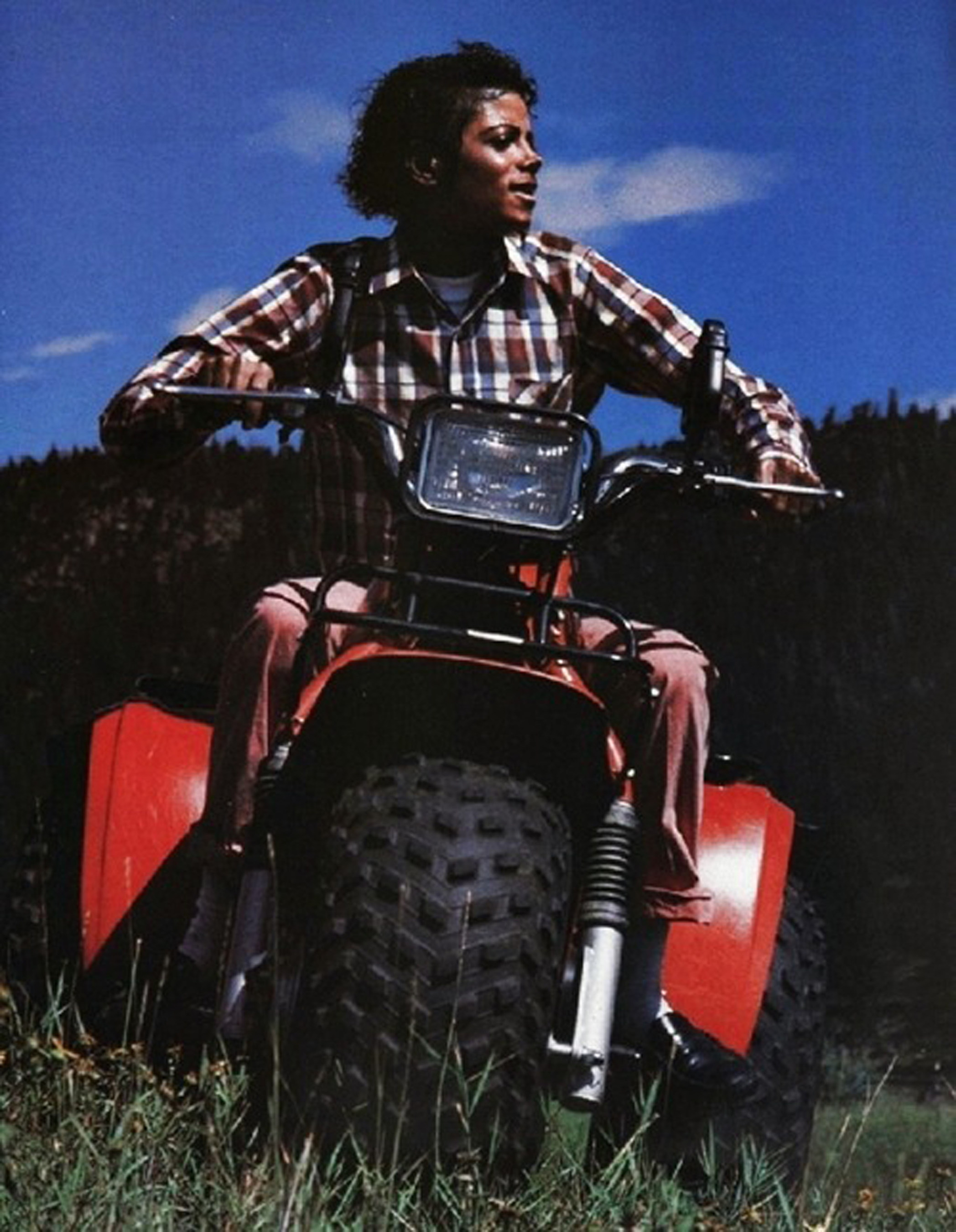 Photo credit: Sam Emerson. Michael Jackson riding a Honda ATC three wheeler at Caribou Ranch in 1984. Jackson spent a private week at Caribou after the Denver leg of The Jacksons' Victory Tour. This vehicle is being sold at auction by Leslie Hindman Auctioneers on January 24. It is being sold with a Victory Tour album and the People Weekly Extra featuring a photo of Michael using the ATC.