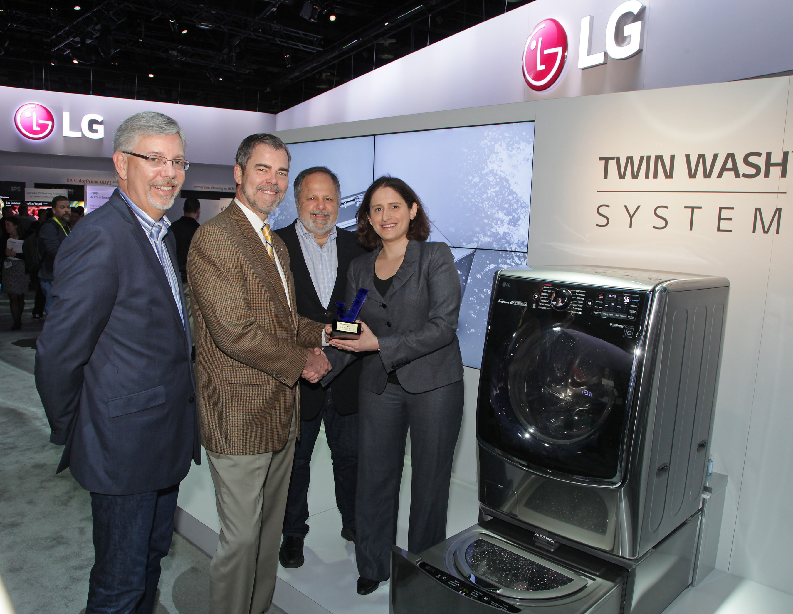 Reviewed.com President and CEO, Robin Liss, President and Publisher of USA Today, Larry Kramer, and President, U.S. Community Publishing at Gannett Company, Inc., Bob Dickey, present David VanderWaal, head of marketing for LG Electronics USA, with the Reviewed.com CES Editors' Choice Award for LG's TWIN Wash System at the 2015 INTERNATIONAL CES(R).