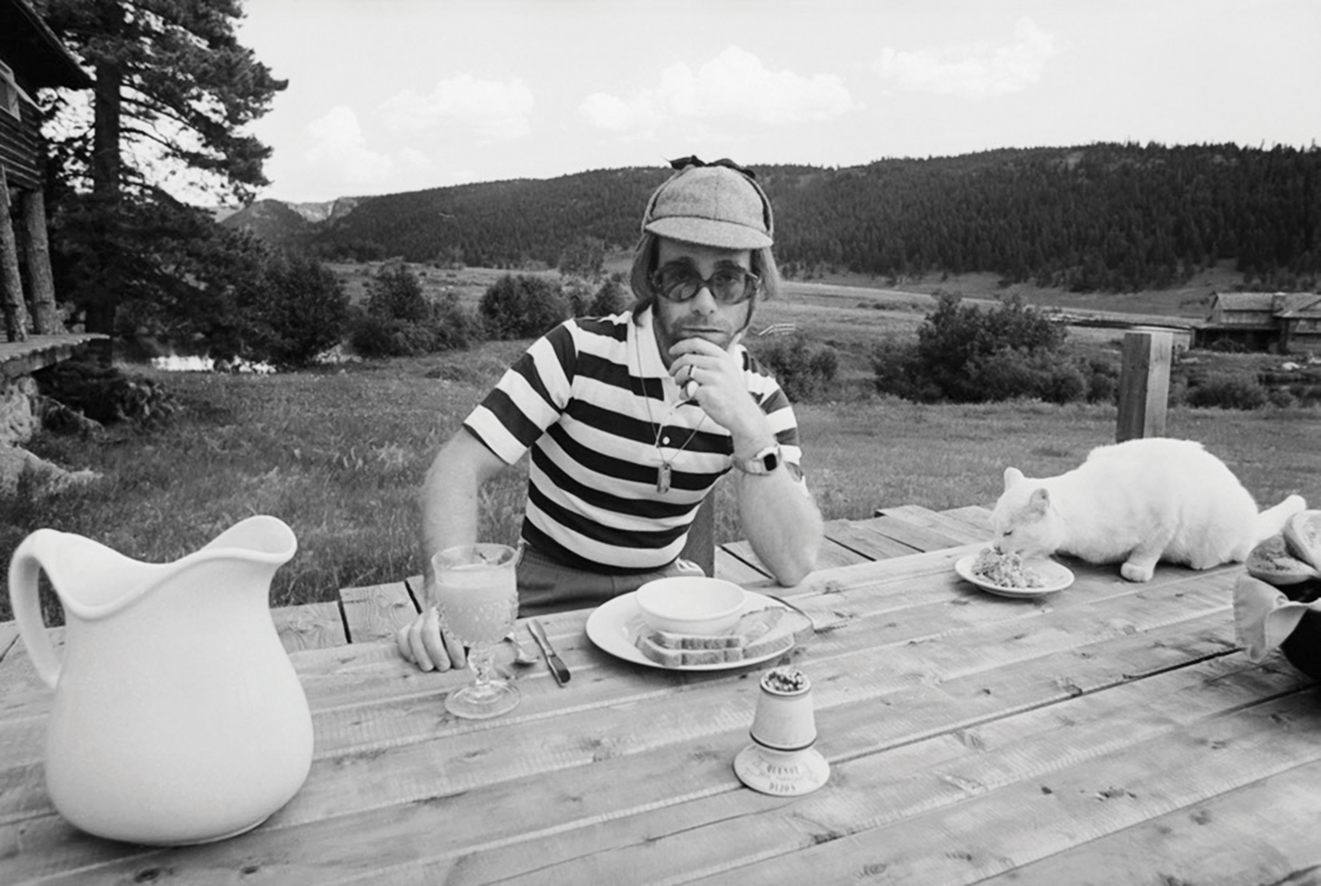 Elton John at Caribou Ranch, where he recorded three albums, with a porcelain dinner service available at auction by Leslie Hindman Auctioneers on January 24. The dinner service includes 189 items total, including the pitcher, plate and bowl pictured here. Both the indoor and outdoor furniture used in the Mess Hall and Lodge are also for sale. The Lodge is where artists such as Al Green and Billy Joel stayed while at Caribou Ranch.