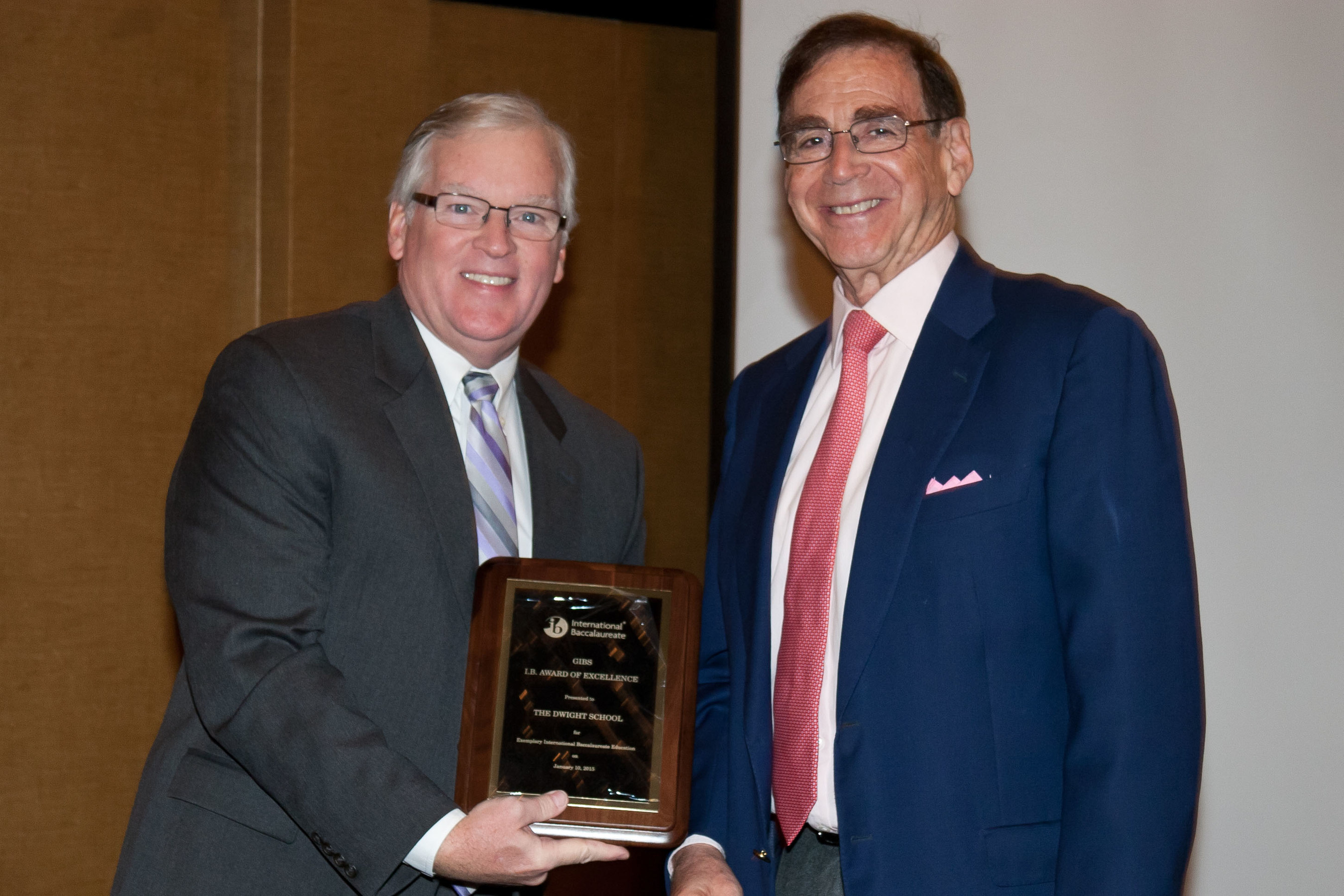 Dwight School Chancellor Stephen Spahn, right, receives a GIBS School of Excellence Award from GIBS President Art Arpin.