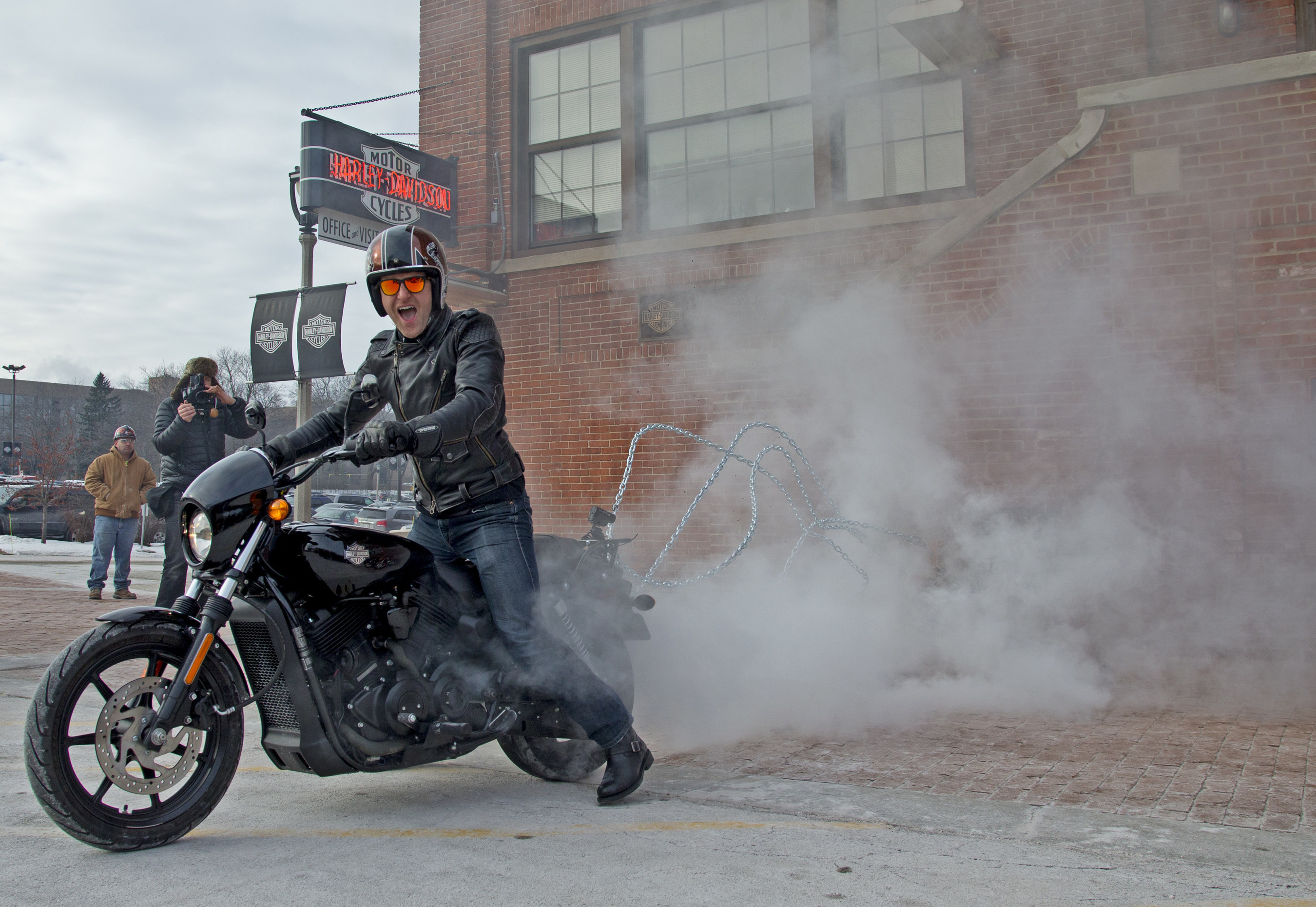 A Harley-Davidson employee removes a brick from the historic Milwaukee headquarters using a 2015 Harley-Davidson Street(R) 750 motorcycle. In the spirit of this year's 75th Sturgis Motorcycle Rally, that brick, alongside one from the Harley-Davidson Museum and 73 bricks from the headquarters' famous motorcycle-only parking area, will be incorporated into the design of a new permanent plaza built by Harley-Davidson on Main Street in Sturgis, S.D. (AP Photo/Jeffrey Phelps)