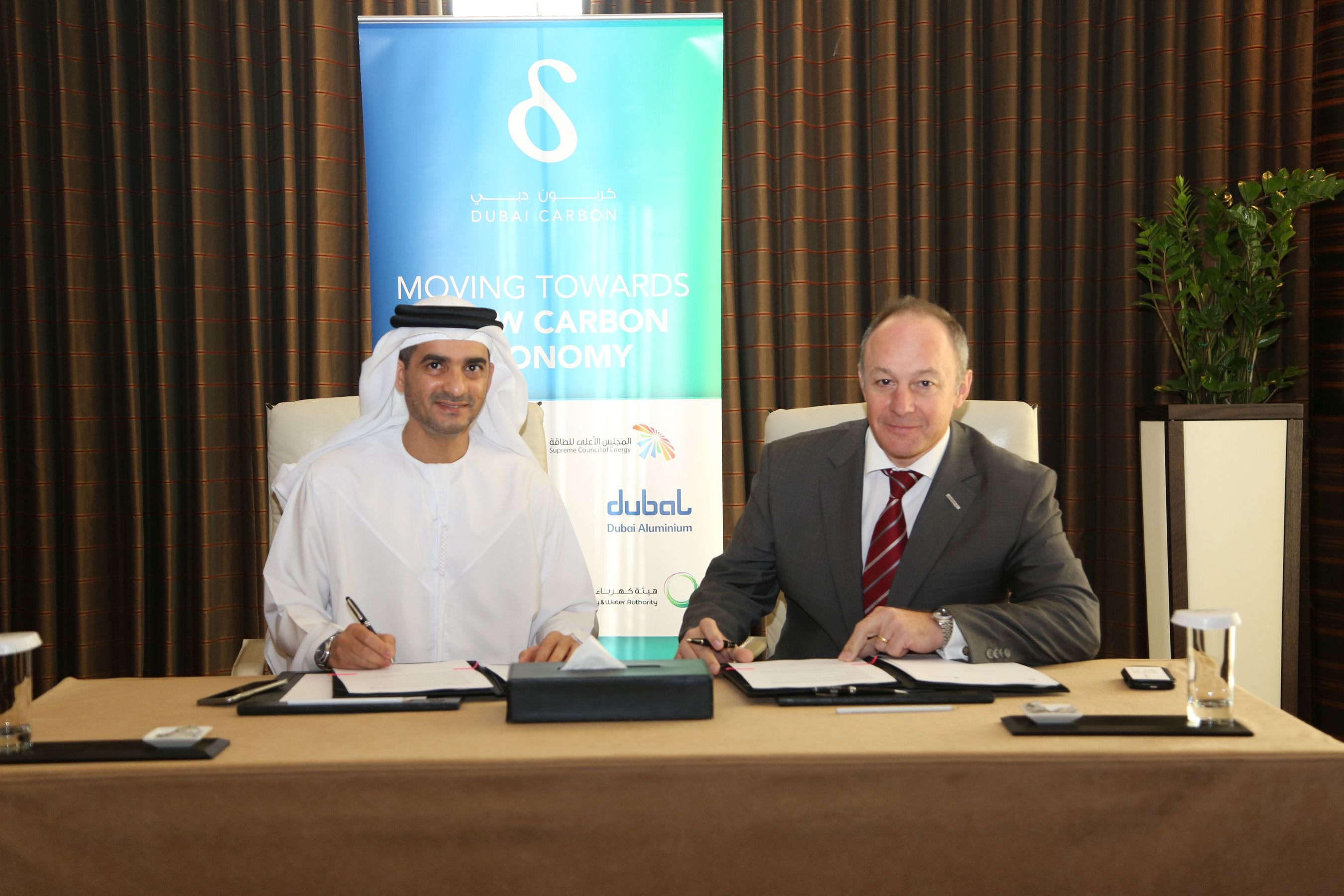 DCCE Chairman Waleed Salman and CH2M HILL's Neil Reynolds sign MoU to support Dubai Carbon Ambassador Program (PRNewsFoto/CH2M HILL)