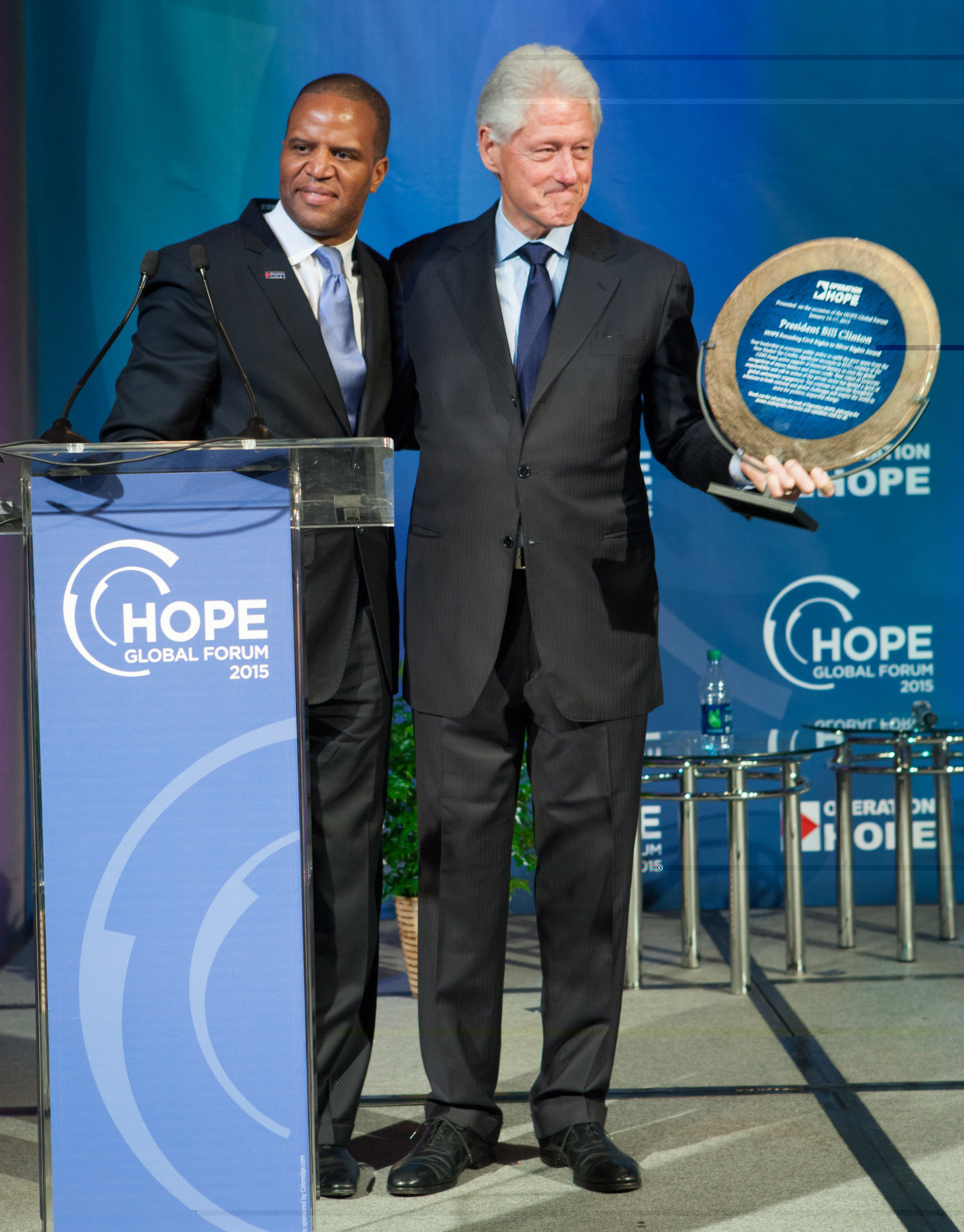 Operation HOPE president and founder John Hope Bryant presents the "Civil Rights to Silver Rights Award" to President Bill Clinton.