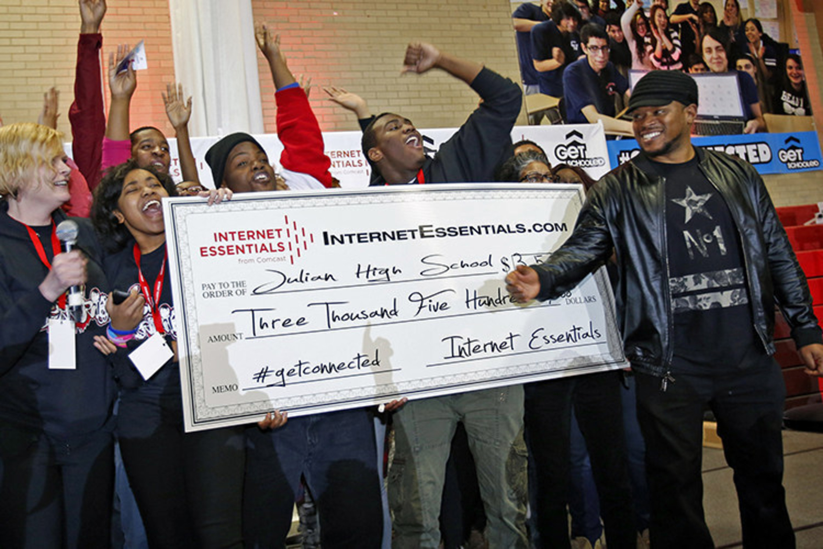 Sway Calloway from MTV presents a check to Julian High School during the Get Schooled, #GetConnected Celebration.