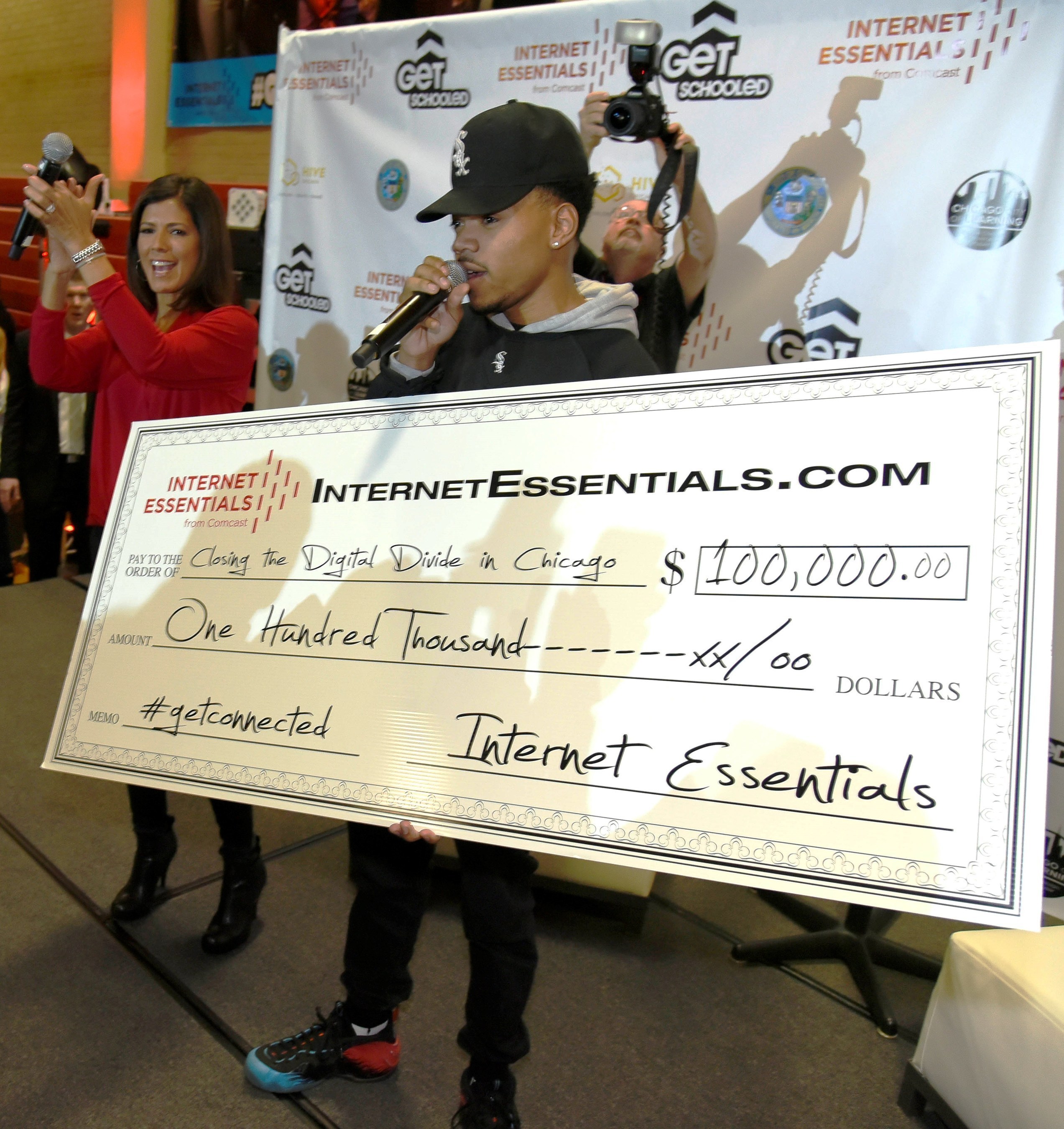 Chance the Rapper makes a $100,000 check presentation apart of the Get Schooled, #GetConnected Celebration.