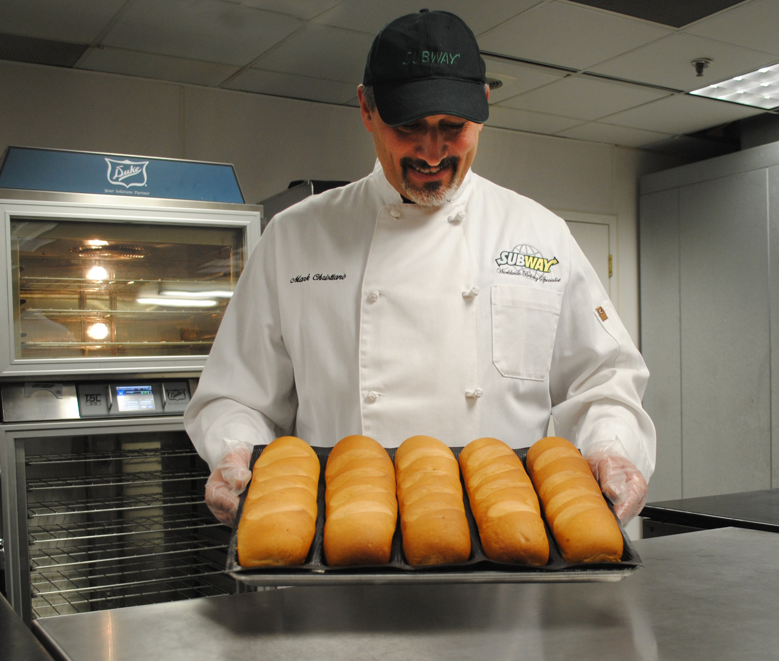 SUBWAY restaurant chain recognizes its bread suppliers for making its bread even better! SUBWAY Baking Specialist Mark Christiano pulls freshly baked bread from the oven.