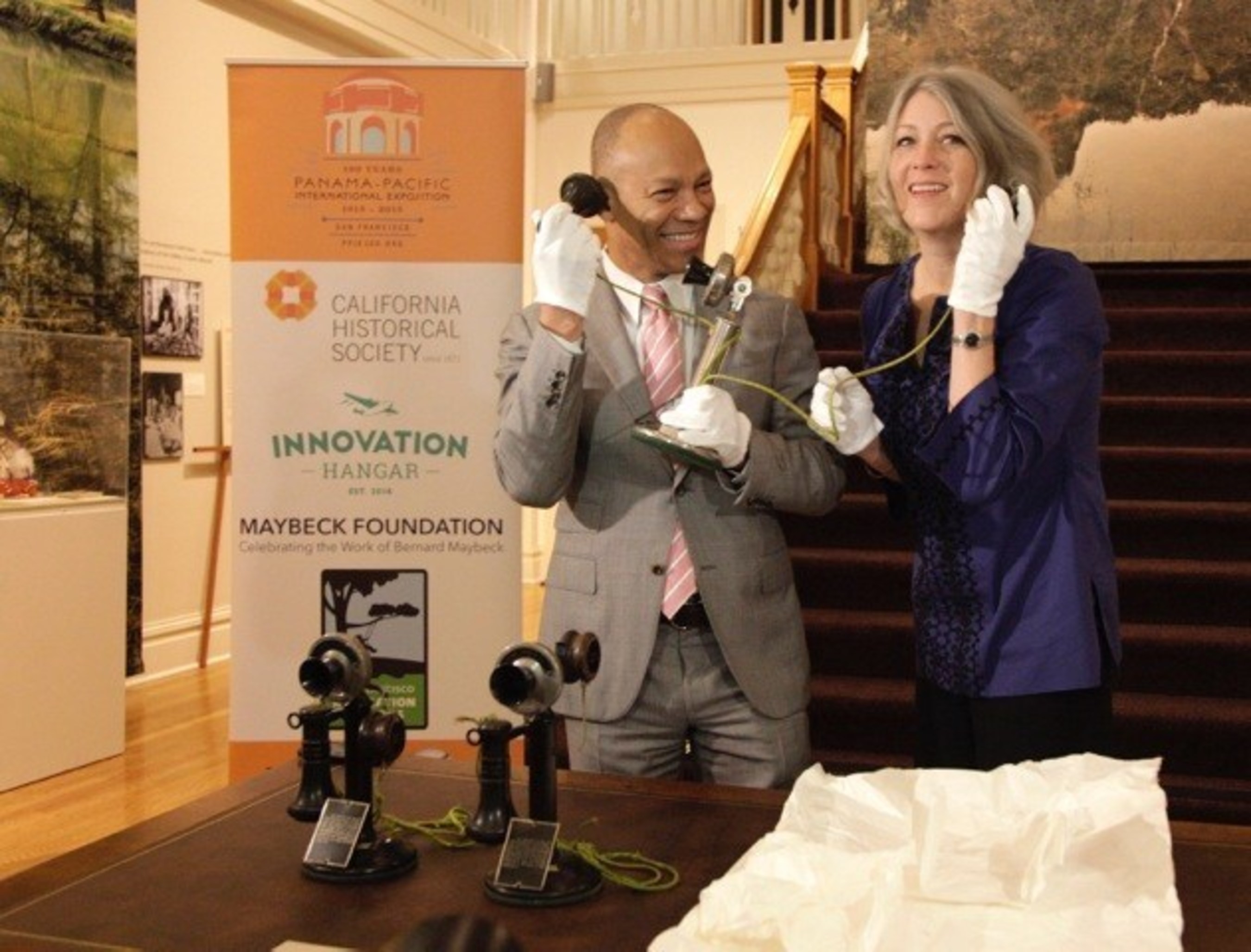 Ken McNeely, President of AT&T California and Dr. Anthea Hartig, Executive Director of the California Historical Society, unpack the original phone used by President Woodrow Wilson to make the first-ever transcontinental phone call on January 25, 1915. The four original phones used for the call were unveiled today and will be on display at the California Historical Society as part of its PPIE100 "City Rising: San Francisco and the 1915 World Fair" exhibition at 678 Mission Street which officially opens on February 22nd in San Francisco. City Rising, will also feature a sister exhibition at the Palace of Fine Arts which opens February 21st as part of a city-wide celebration and community day at the Palace that marks the 100th anniversary of the 1915 World's Fair. Photo Source: Michael Tweed