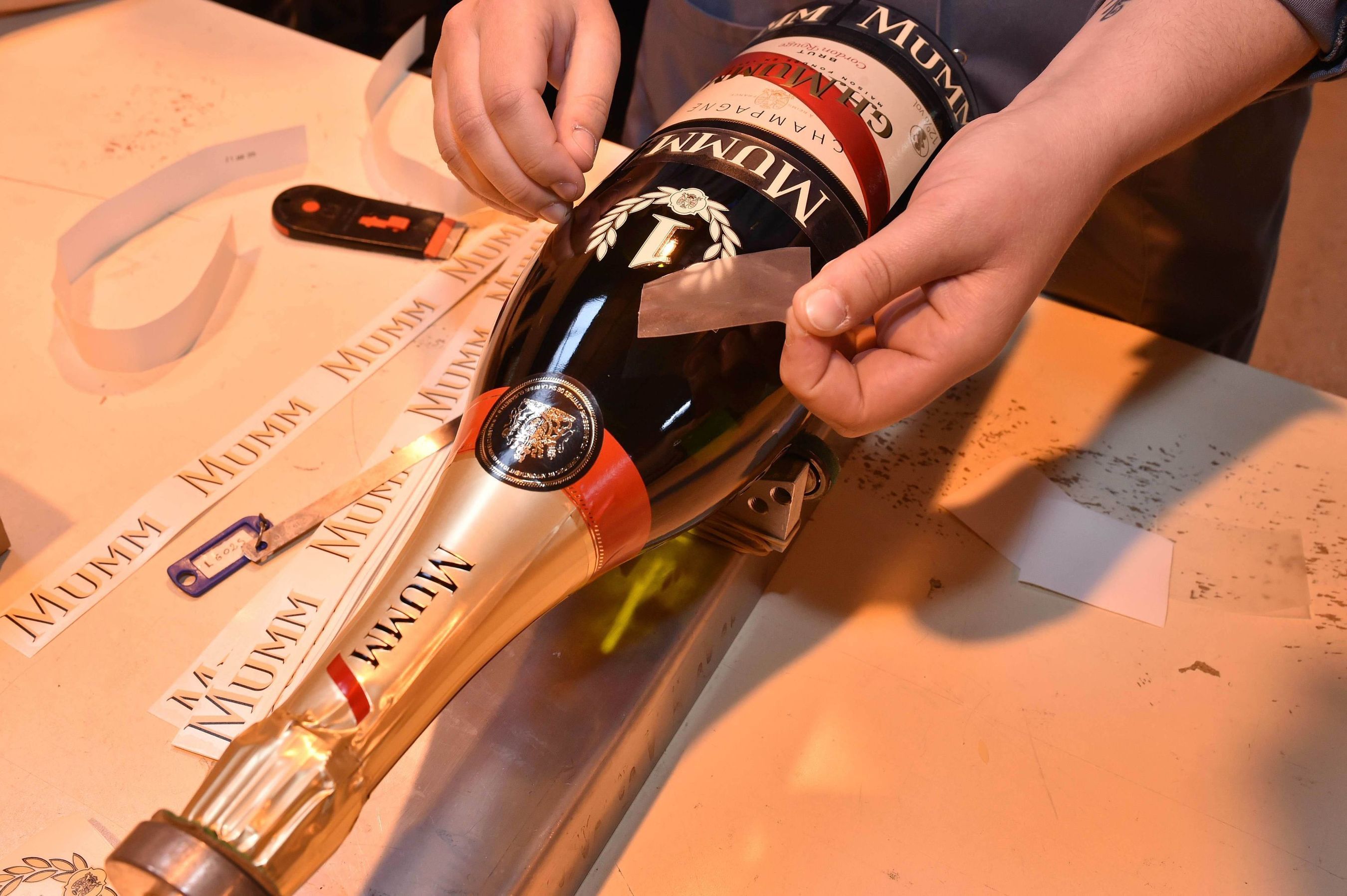 Before beginning its journey to the celebratory podium in Monte Carlo, the final preparations are made to the iconic Jeroboam of Cordon Rouge that will be awarded to the winner of the 2015 Monaco Grand Prix. (PRNewsFoto/Maison Mumm)