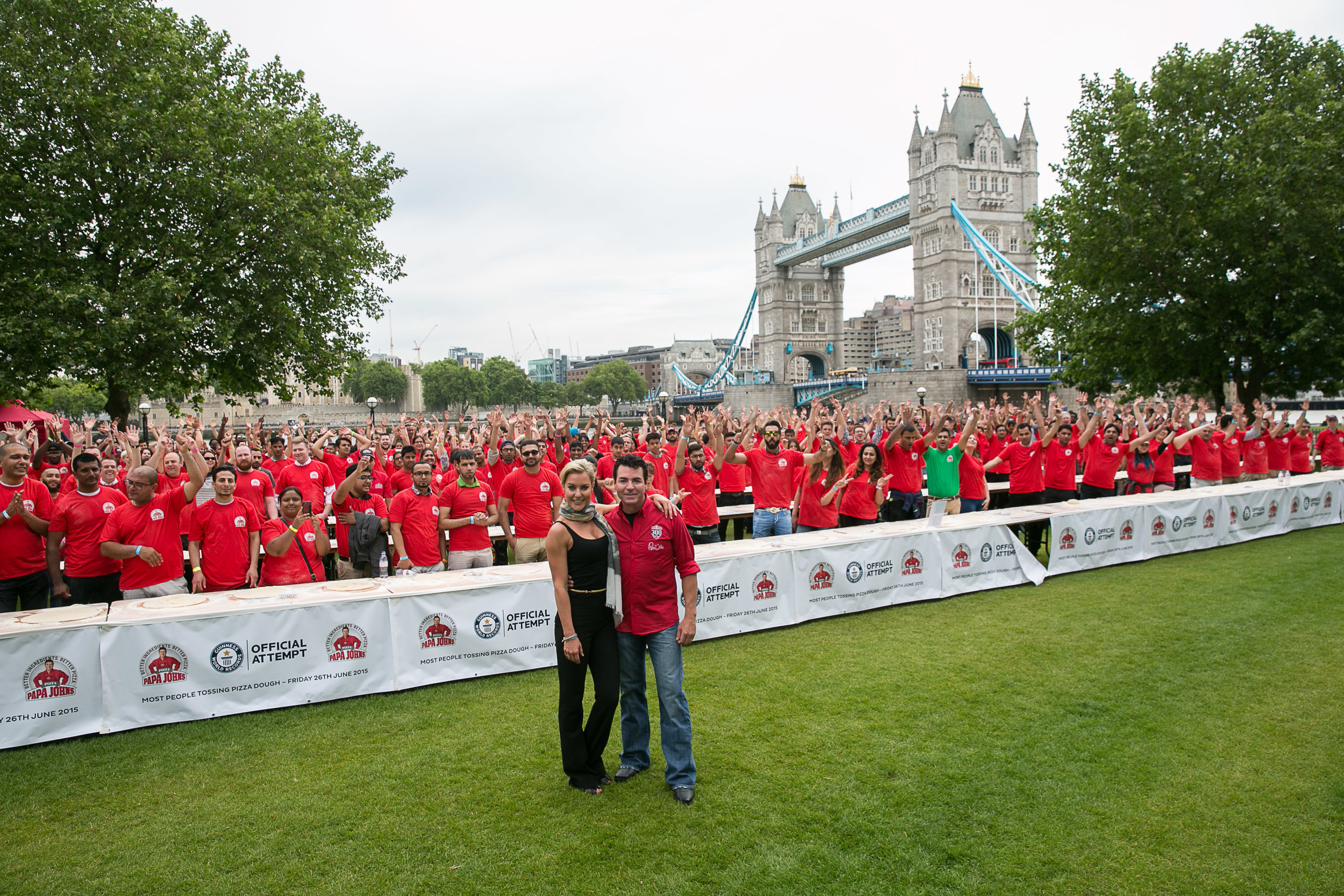 Papa John's Founder, John Schnatter, and Natalie Lowe, star of Strictly Come Dancing, pose for a photo after breaking a GUINNESS WORLD RECORD with 338 people tossing pizza at once. (PRNewsFoto/Papa John's) (PRNewsFoto/Papa John's)