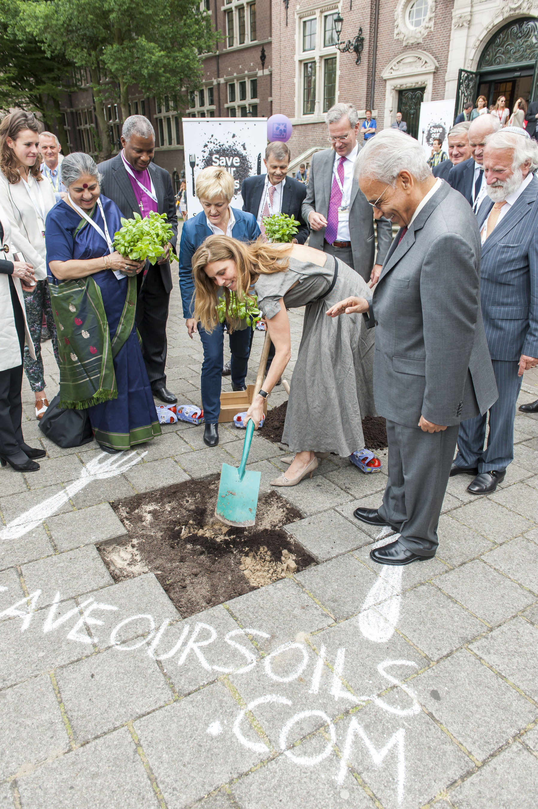In a guerrilla gardening action in the heart of Amsterdam, German TV-cook Sarah Wiener is wielding the spade. Around her, from left to right are Joszi Smeets of the Youth Food Movement, Vandana Shiva, archbishop Thabo Makgoba, Renate Kunast, Andre Leu of IFOAM, Volkert Engelsman of Nature & More, Ibrahim Abouleish of SEKEM (front), GÃƒÂ¶tz Rehn of Alnatura and Rabbi Soetendorp. (PRNewsFoto/Nature & More / Save Our Soils) (PRNewsFoto/Nature & More / Save Our Soils)