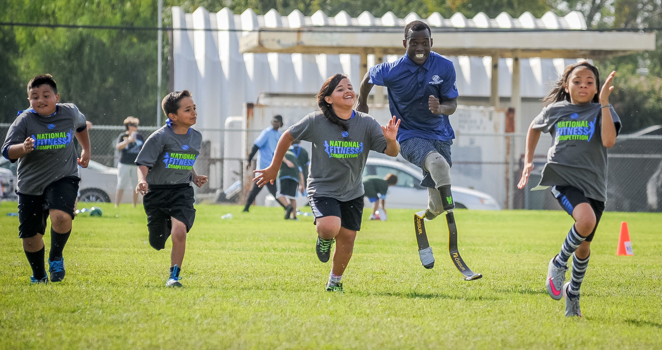 Paralympic athlete Blake Leeper races with Boys & Girls Club kids in Bakersfield, California during Boys & Girls Clubs of America and Nestle's National Fitness Competition.