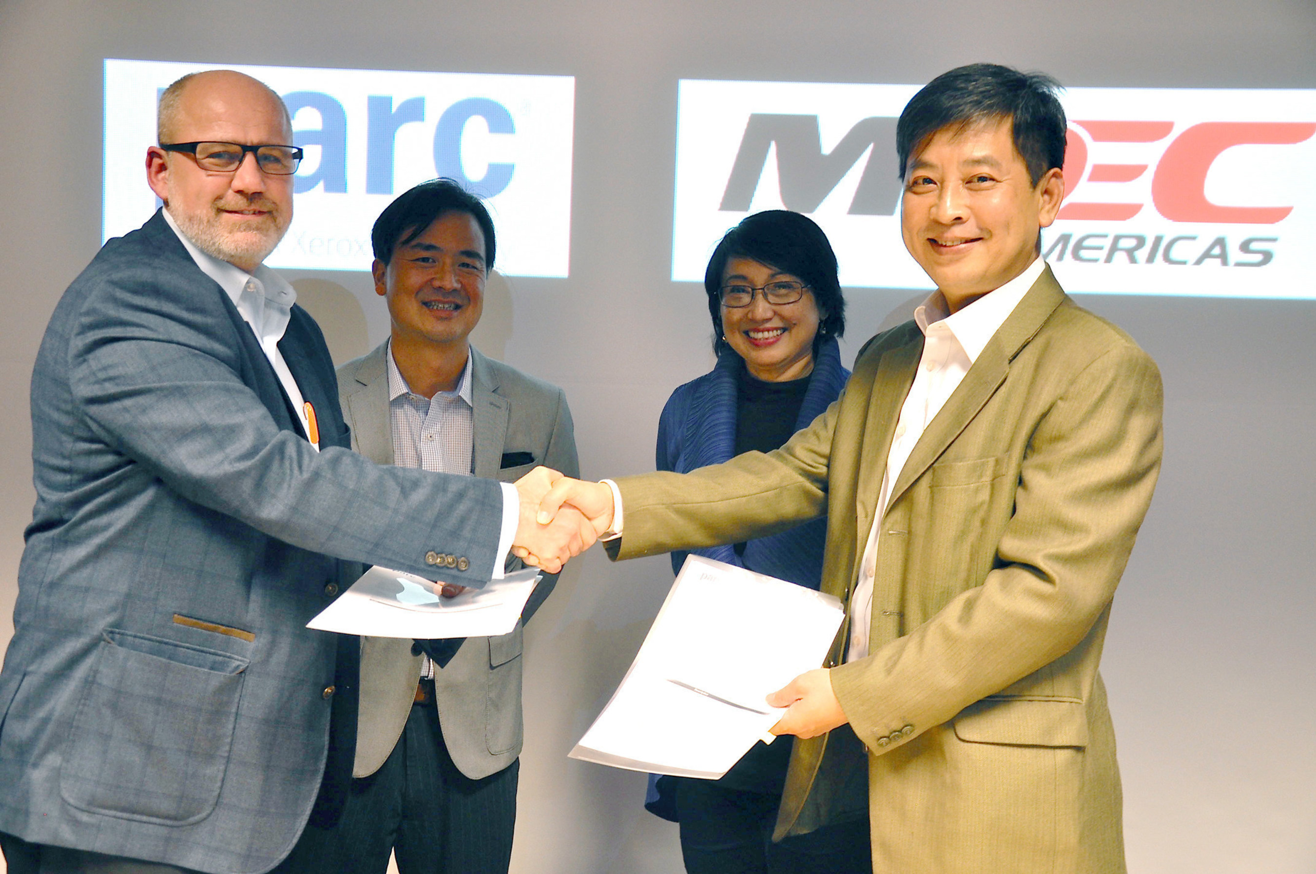 PARC MoU exchange by Stephen Hoover, CEO of PARC & Dato' Dan E Khoo, President of MDeC Americas (foreground, left to right), witnessed by Aki Ohashi, PARC’s Director of Business Development and Dato' Yasmin Mahmood, CEO of MDeC (second row, left to right)