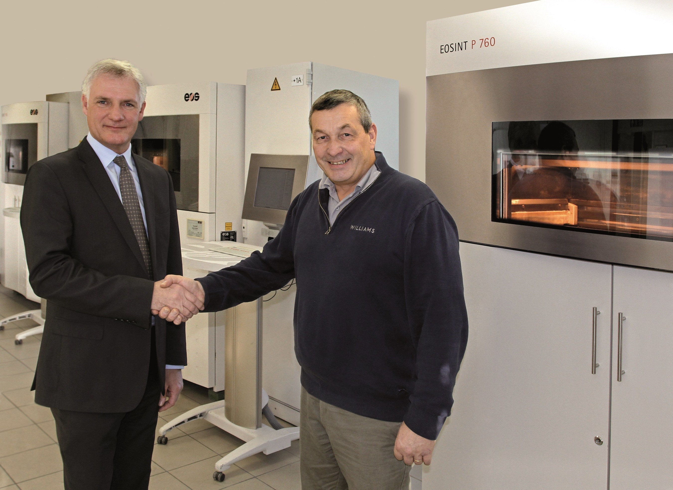 (f.l.t.r.) Stuart Jackson, Regional Manager EOS UK with Richard Brady, Advanced Digital Manufacturing Leader, in front of an EOSINT P 760 system (Source: EOS) (PRNewsFoto/EOS) (PRNewsFoto/EOS)