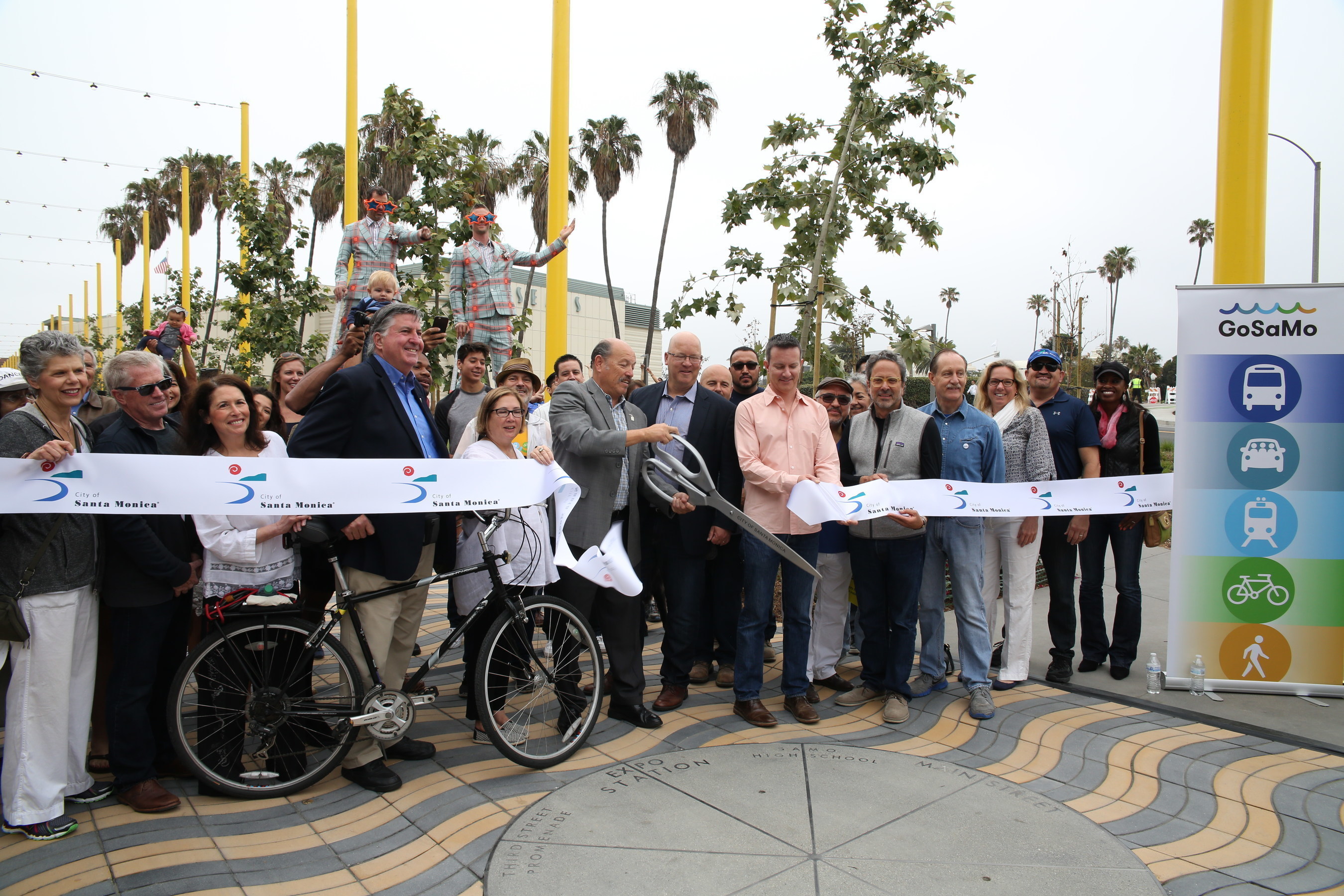 Santa Monica Mayor Tony Vazquez cuts the ribbon at the grand opening of the Colorado Esplanade, a new pedestrian and bikeway connecting the Downtown Santa Monica Expo Station to the Santa Monica Pier. Also photographed (left to right): Assistant City Manager, Elaine Polachek; Construction Manager, Gene Higginbotham; Councilmember Sue Himmelrich; Councilmember Kevin McKeown; Councilmember Gleam Davis; Mayor Tony Vazquez; Mayor Pro Tempore, Ted Winterer; Councilmember Terry O'Day; Metro Executive Officer...