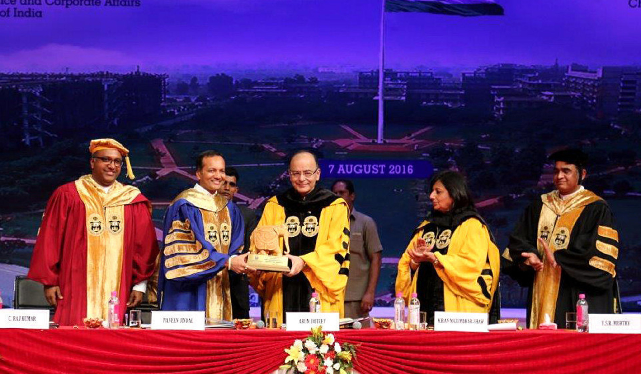 JGU Chancellor, Mr. Naveen Jindal presenting a token of appreciation to Shri Arun Jaitley, Hon'ble Union Minister of Finance and Corporate Affairs in the presence of Ms. Kiran Mazumdar-Shaw, Chairperson and Managing Director, Biocon Limited and JGU Vice-Chancellor, Prof (Dr.) C Raj Kumar and Registrar Prof (Dr.) Y.S.R Murthy (PRNewsFoto/O.P. Jindal Global University)