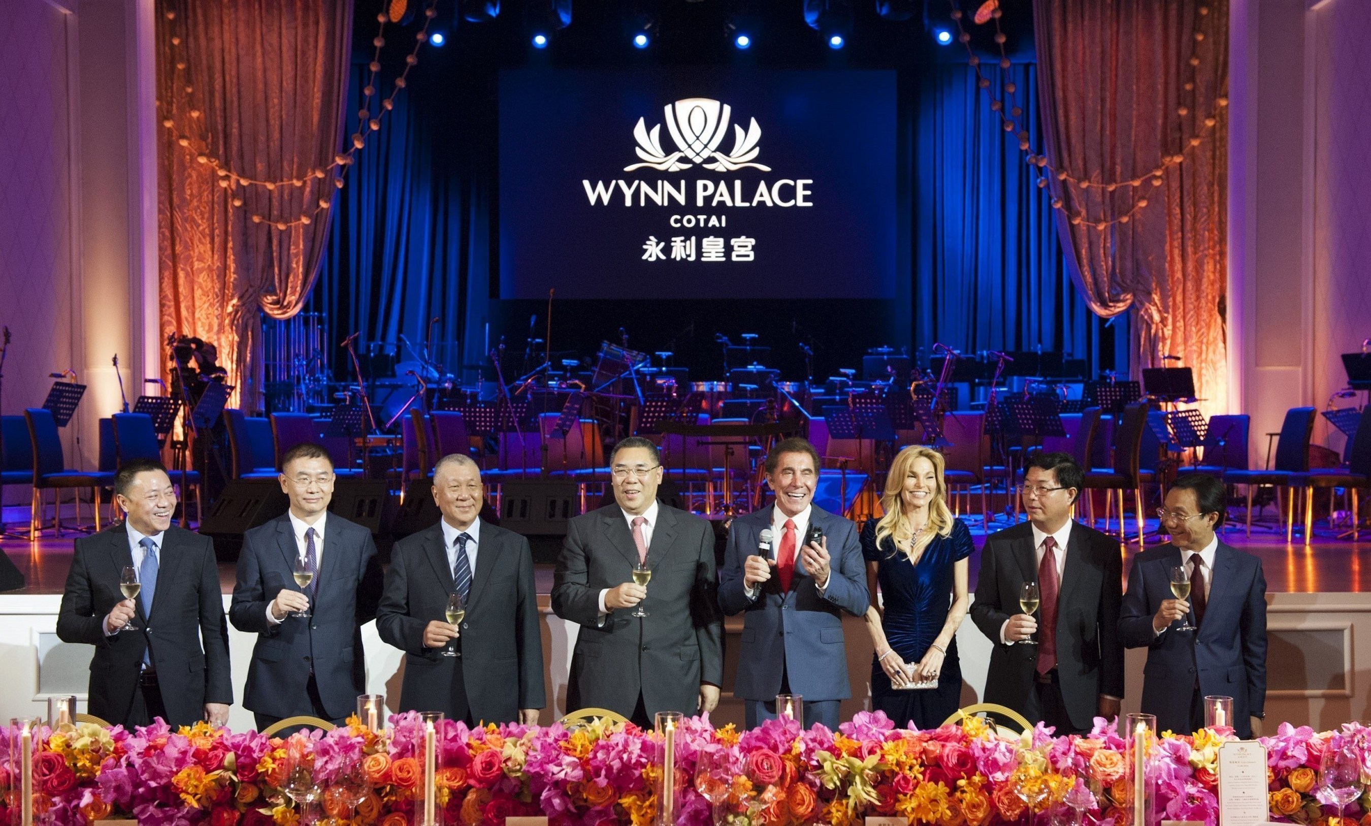 Officiating guests raise a toast at the opening of Wynn Palace.