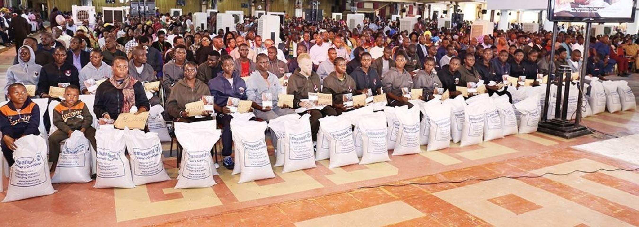 The large group of deportees gratefully receive individual cash gifts of N150,000 ($500USD) and two bags of rice after sharing their sordid experiences at The Synagogue, Church Of All Nations (SCOAN). (PRNewsFoto/Emmanuel TV)